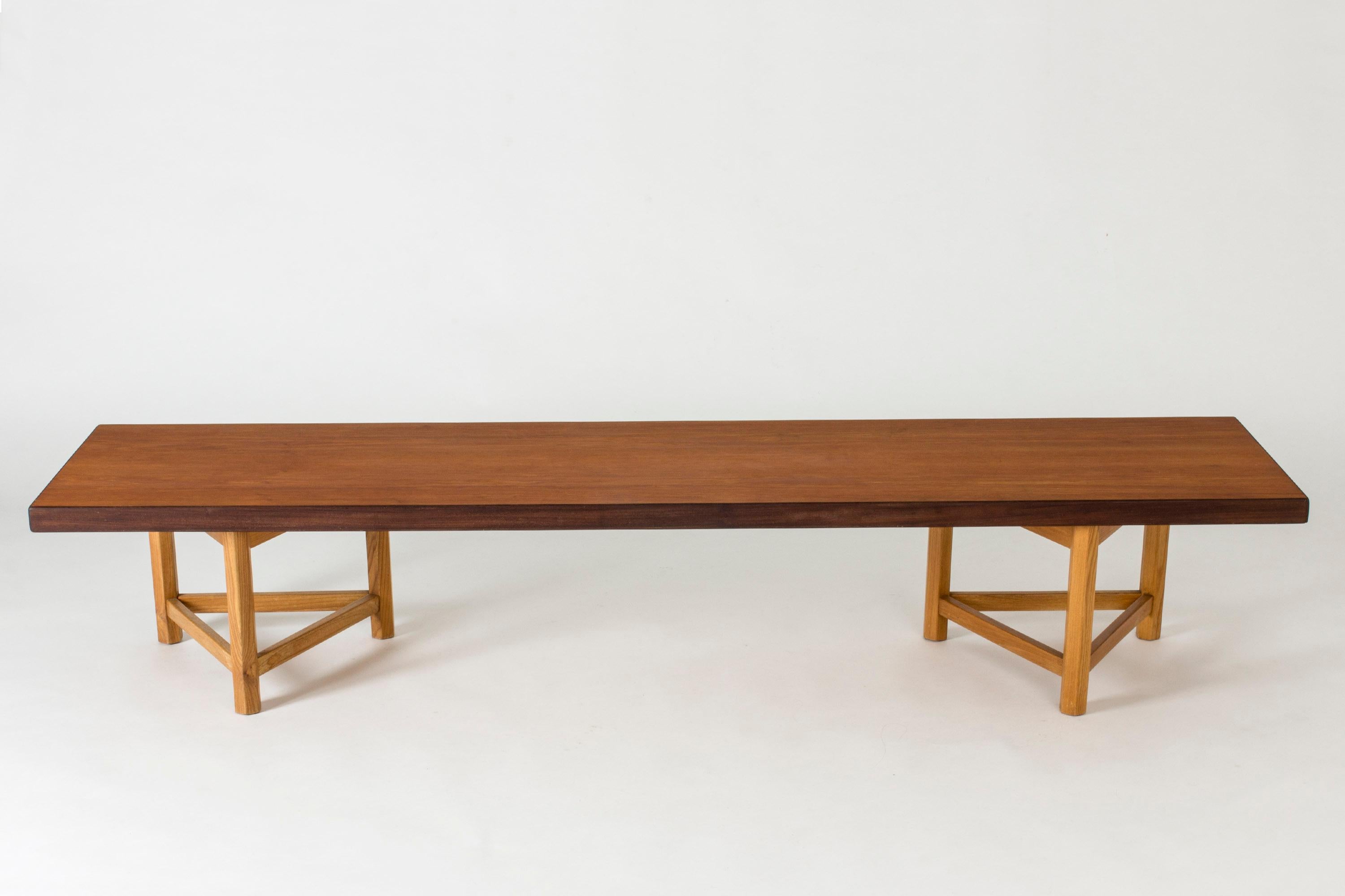 Teak bench with loose oak tripod legs by Finnish interior architect Gustaf Hiort af Ornäs. Works well as a sideboard or room divider. Clean, simplistic lines and great quality.