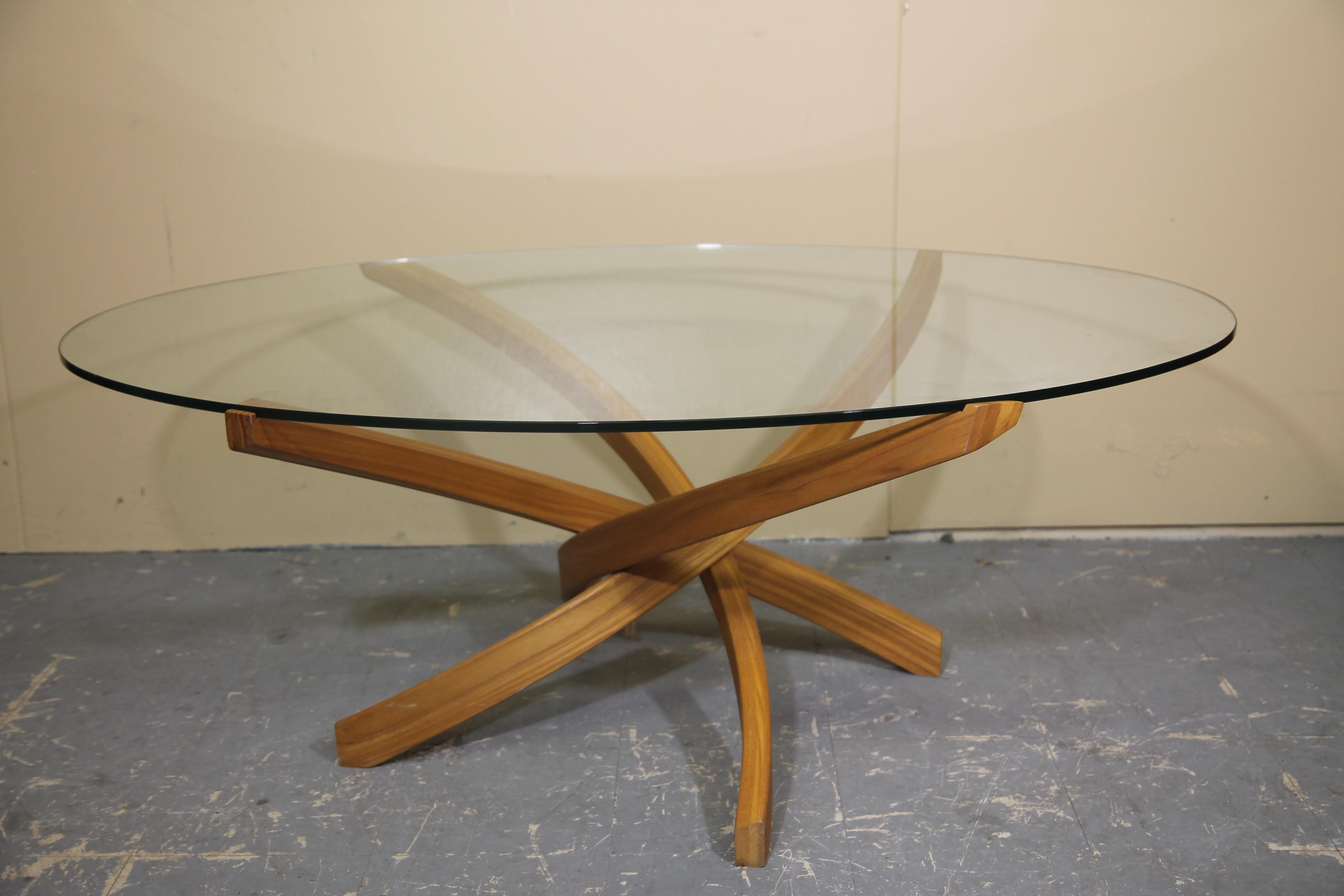Amazing teak bentwood coffee table. Glass sits securely on top of the table in cut outs on each arm. I have never seen this example before. Well made and looks even better in person.