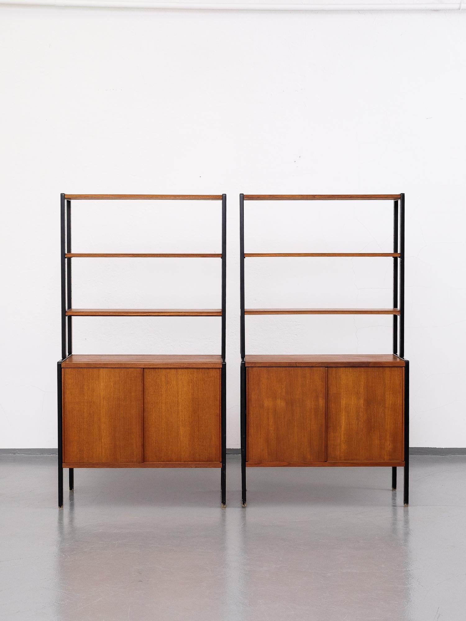 Beautiful and elegant teak bookcases with brass details by Bertil Fridhagen for Bodafors, Sweden, 1950s.

The lower part of the cabinet has two sliding doors, the top part has three shelves.

Marked with 