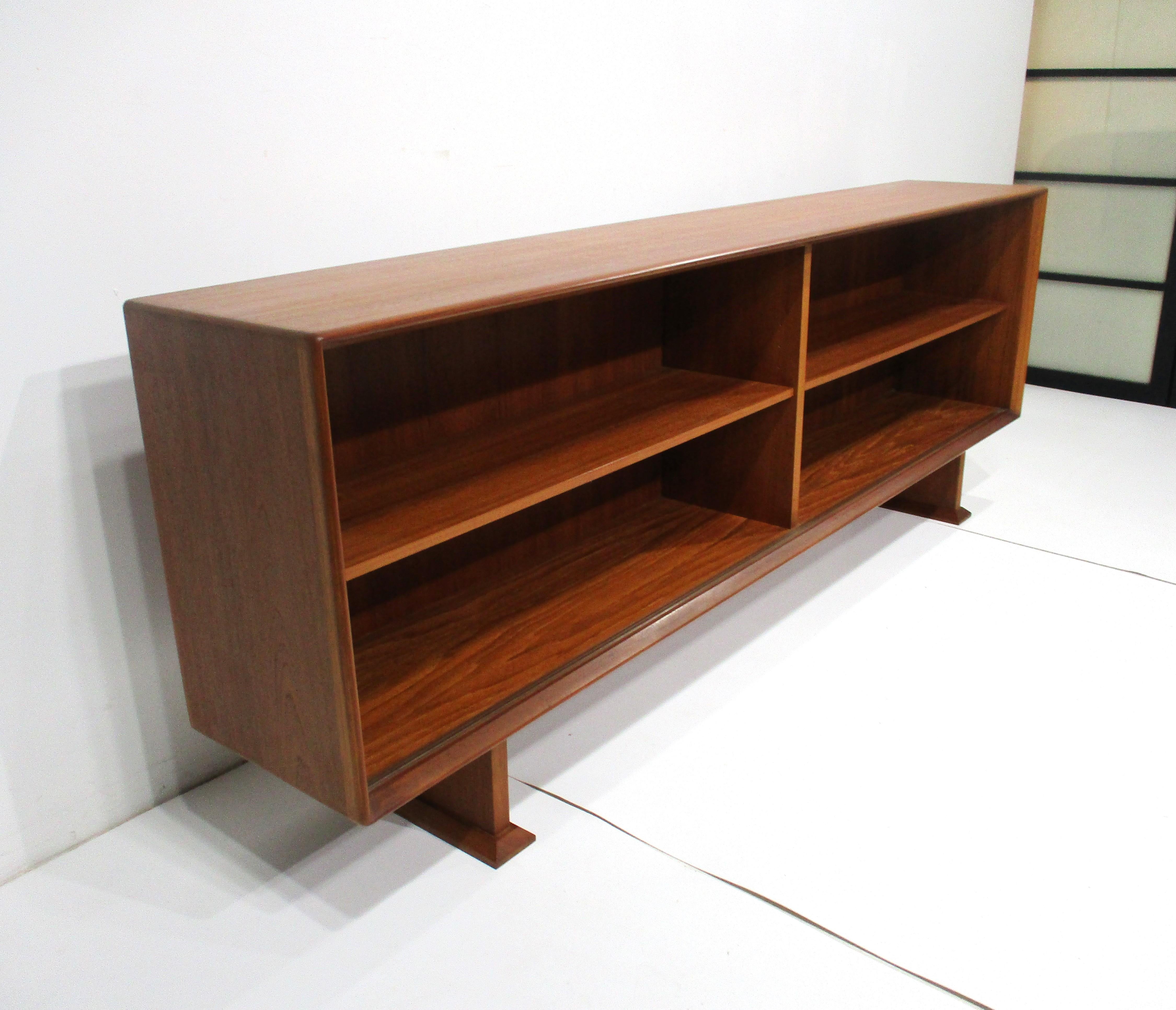A well crafted teak wood bookcase with two adjustable matching shelves having the perfect size and proportions for book storage . Designed by Henry Rosengren Hansen imported by Dylund and made in Denmark , includes two sliding glass doors to protect