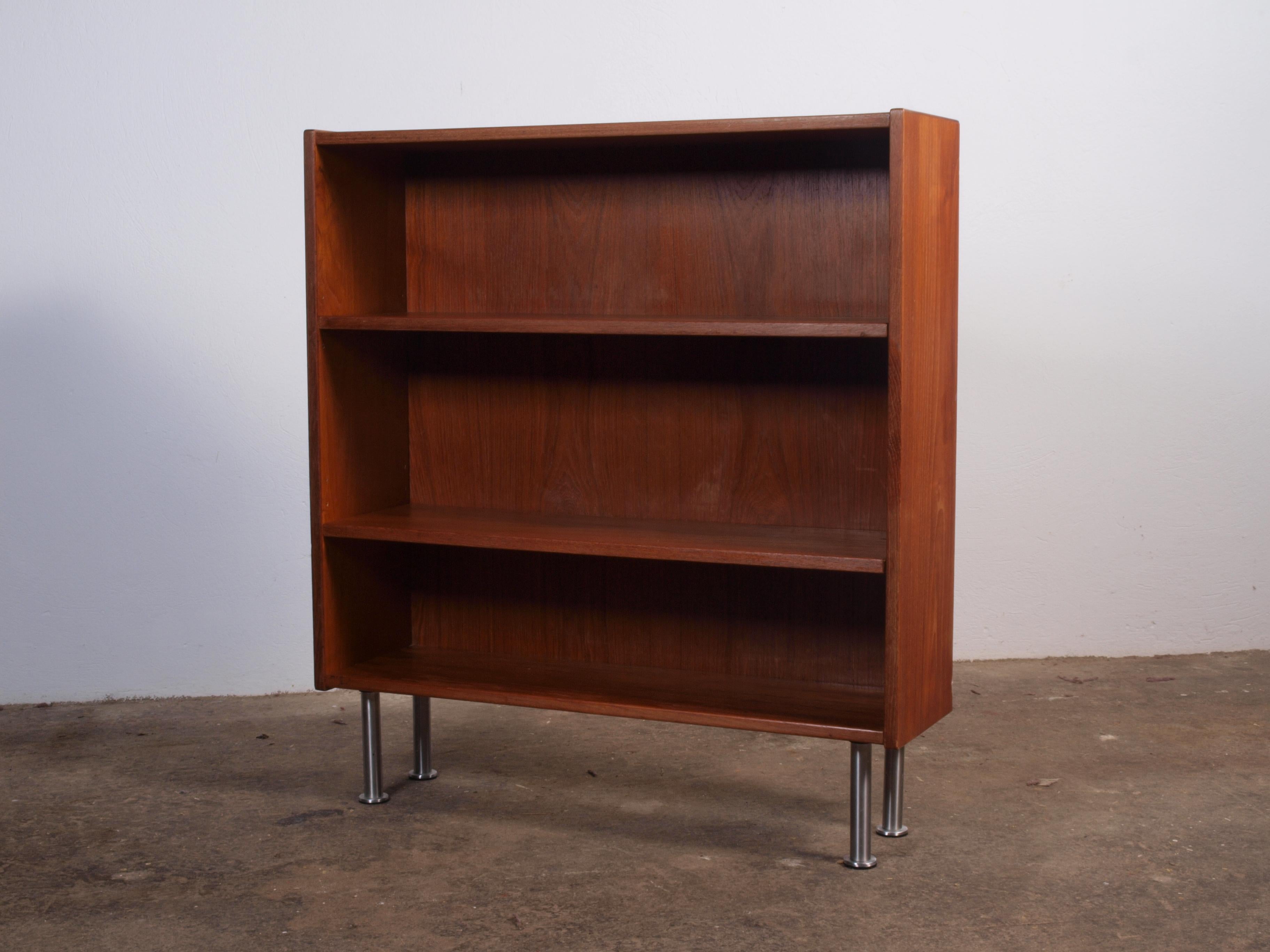 Minimalistic Danish teak book shelf cabinet in teak. In good condition with small marks, see pictures. Please reach out for a customized shipping quote.