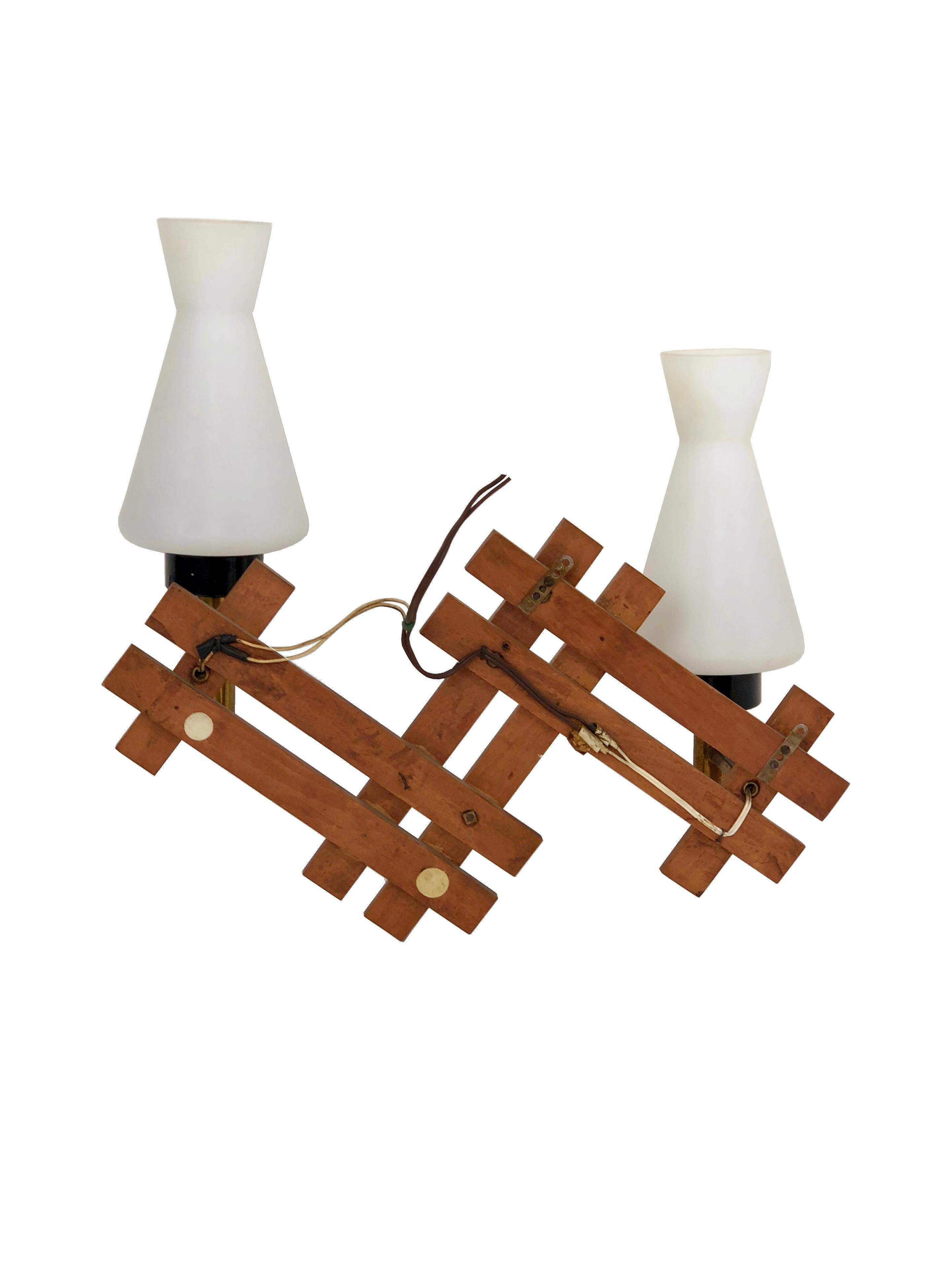 Teak and brass wall sconces featuring two lights in opaline glass, made in Italy during the 1960s.
