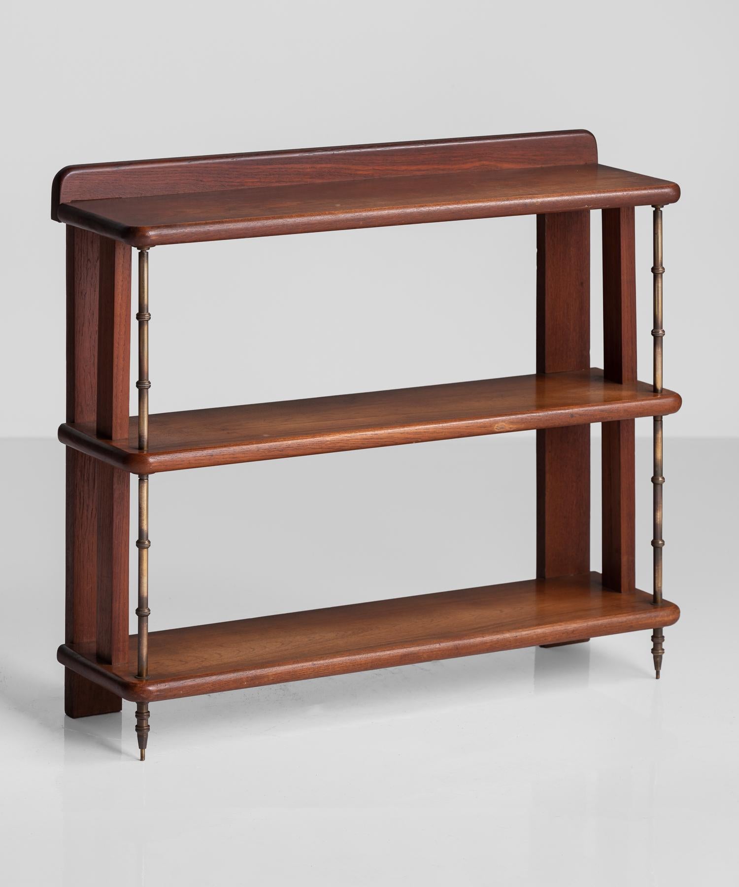 Teak and brass Campaign style Shelves, England, circa 1930.

Simple shelving in teak with rounded edges and brass arms.
