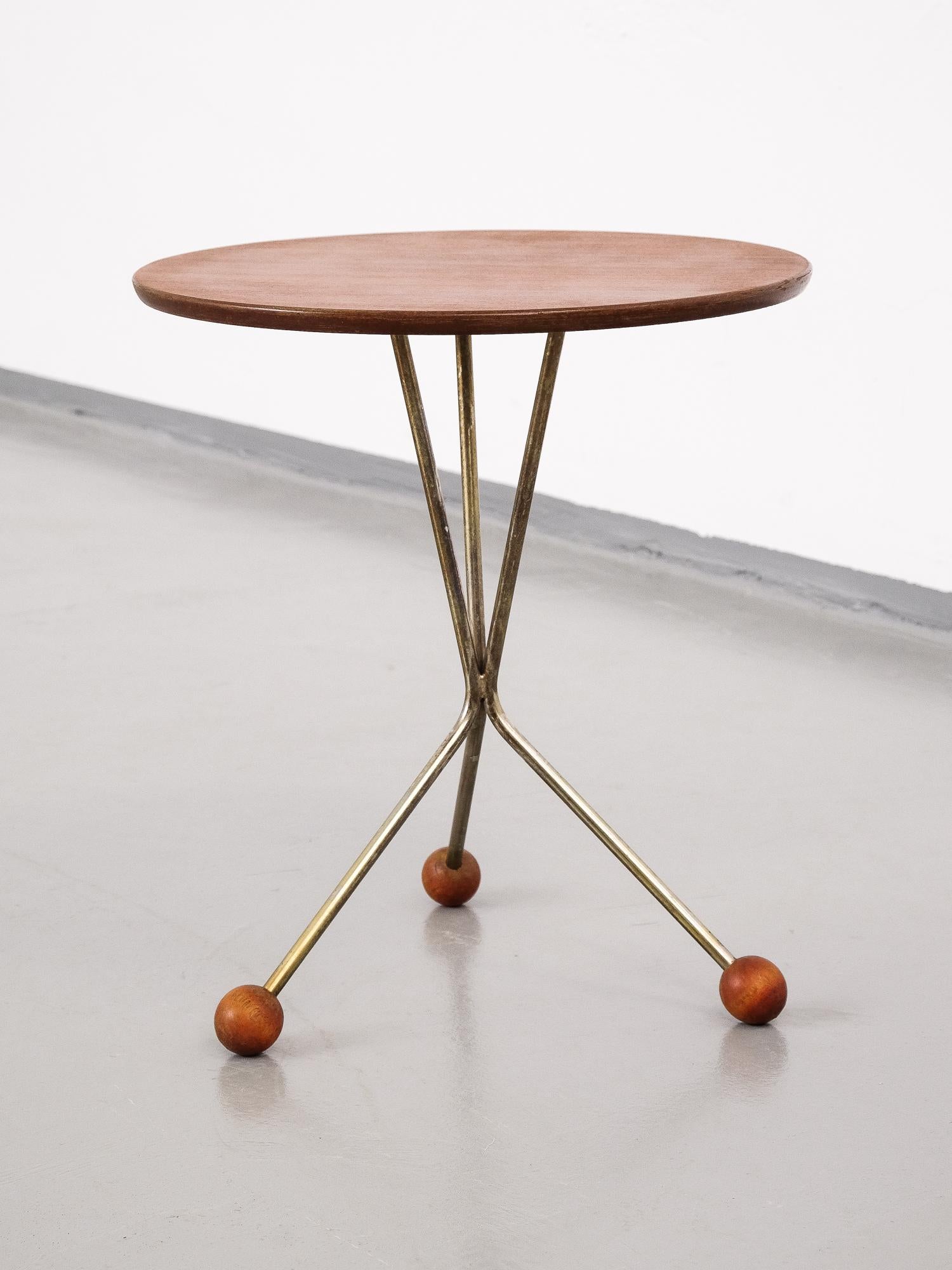 Swedish design side table by Albert Larsson for Alberts Tibro. Brass tripod base, teak top plate. Very good original condition.