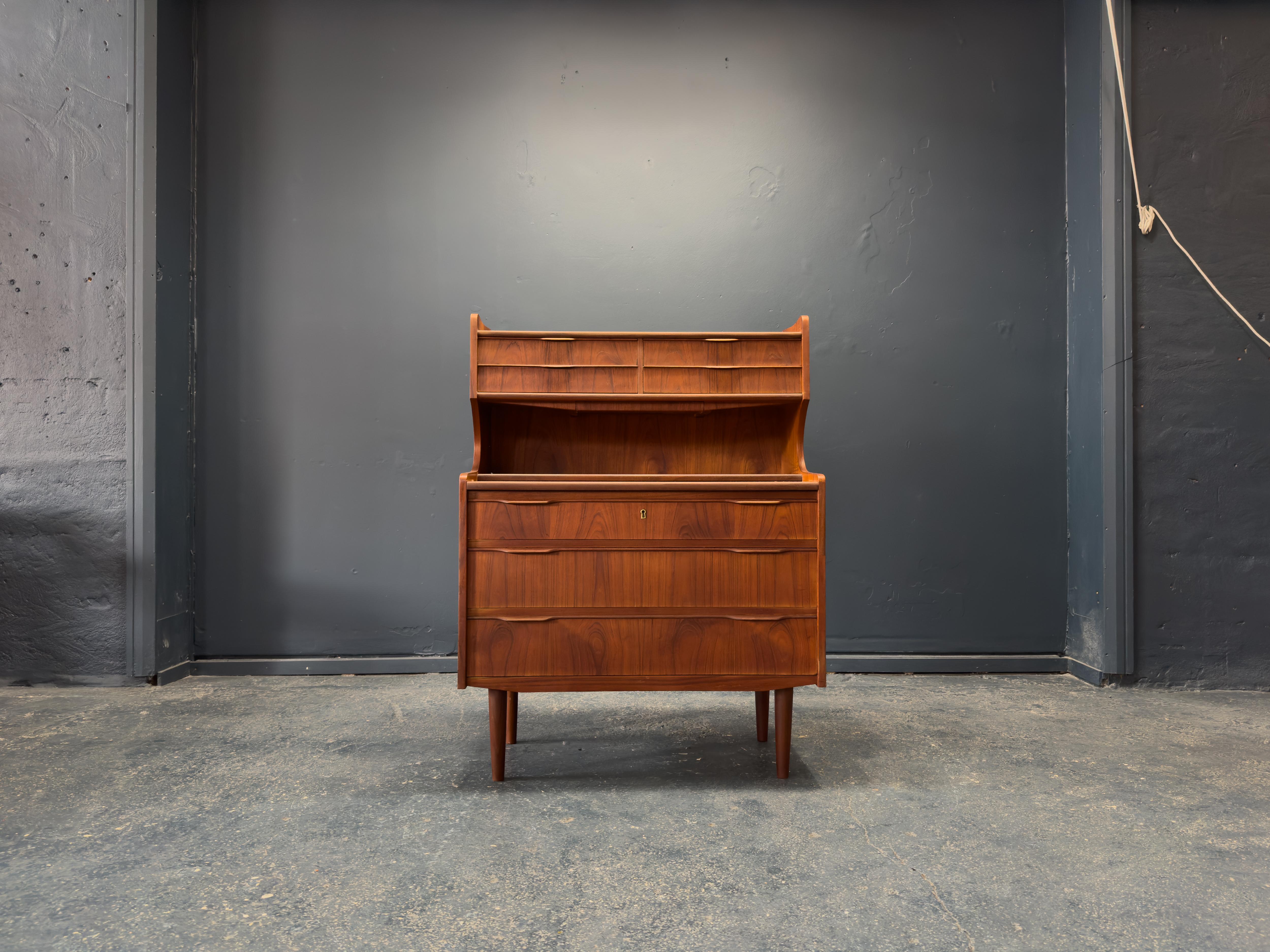 This beautifully crafted teak bureau from the 1960s is a superb example of Danish modernism, showcasing both elegance and functional ingenuity. Made from richly grained solid teak, the piece features smooth lines and sculpted handles that enhance