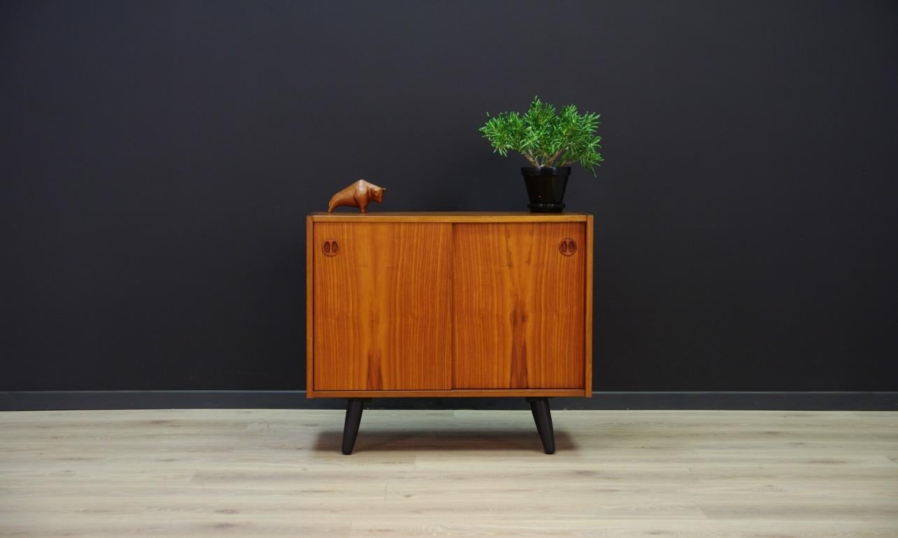 Original chest of drawers from the 1960s-1970s, Minimalist form, Danish design. Roomy interior with adjustable shelf behind the sliding doors, veneered with teak. Preserved in good condition (small bruises and scratches, filled veneer loss),