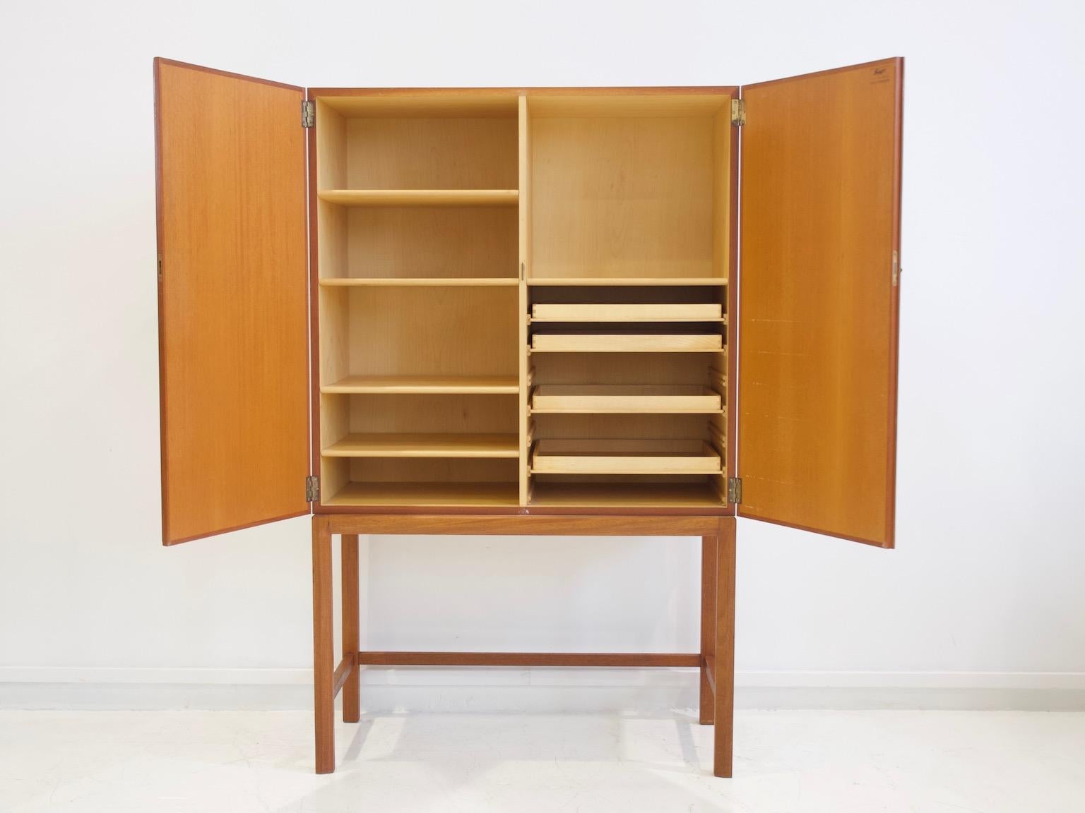 Teak cabinet designed by Axel Larsson (1898-1975) for Bodafors, Sweden in 1961. Interior made of birch. Storage featuring shelves and pull-out trays. Beautiful piece of furniture that can be used as a dining room buffet or in a home office to store