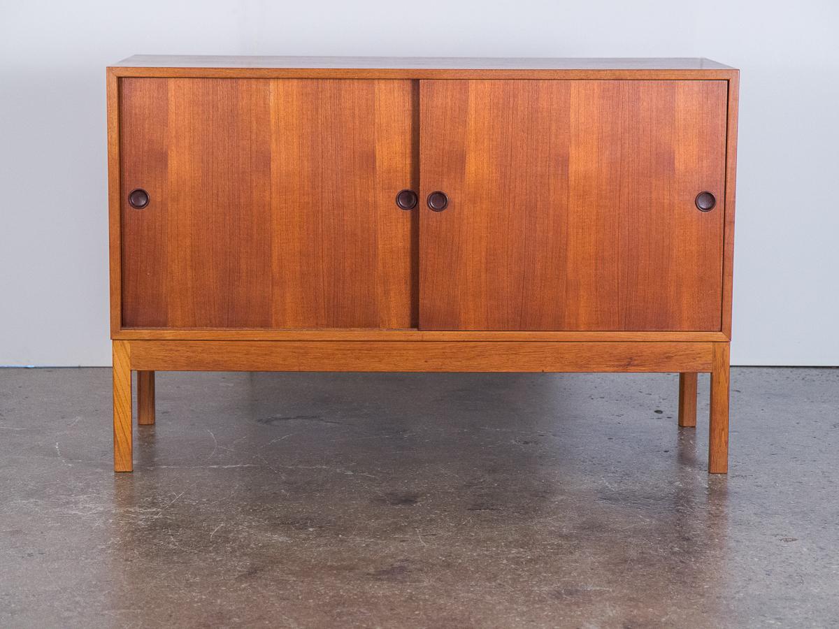 Handsome teak sideboard in beautifully restored condition, designed by Børge Mogensen and manufactured by Karl Andersson & Söner in Sweden. The interior of cabinet is fitted with adjustable wood shelves and lacquered-wood tray drawers that slide on
