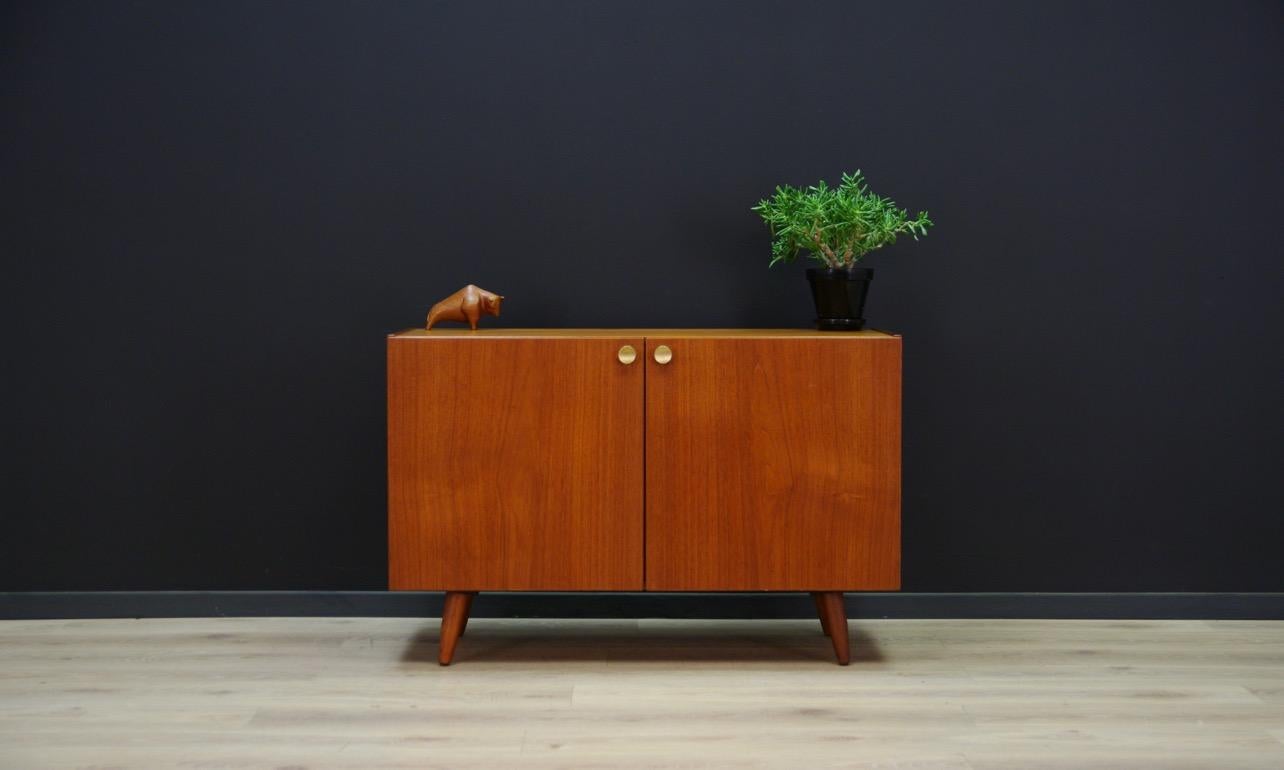 Spacious cabinet from the 1960s-1970s - minimalistic form - Danish design. Form veneered with teak. original handles. Behind the doors there is a shelf. Preserved in good condition (small bruises and scratches) - directly for use.

Dimensions: