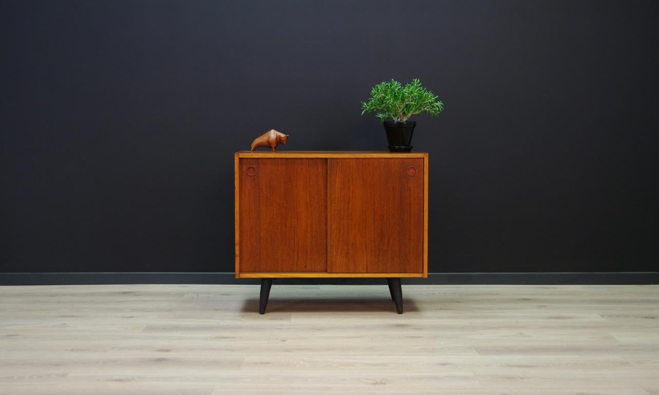 Great cabinet from the 1960s-1970s, Minimalist form - Danish design. The surface veneered with teak. Usable space with adjustable shelf behind the sliding doors. Preserved in good condition (small bruises and scratches, filled with a small loss of