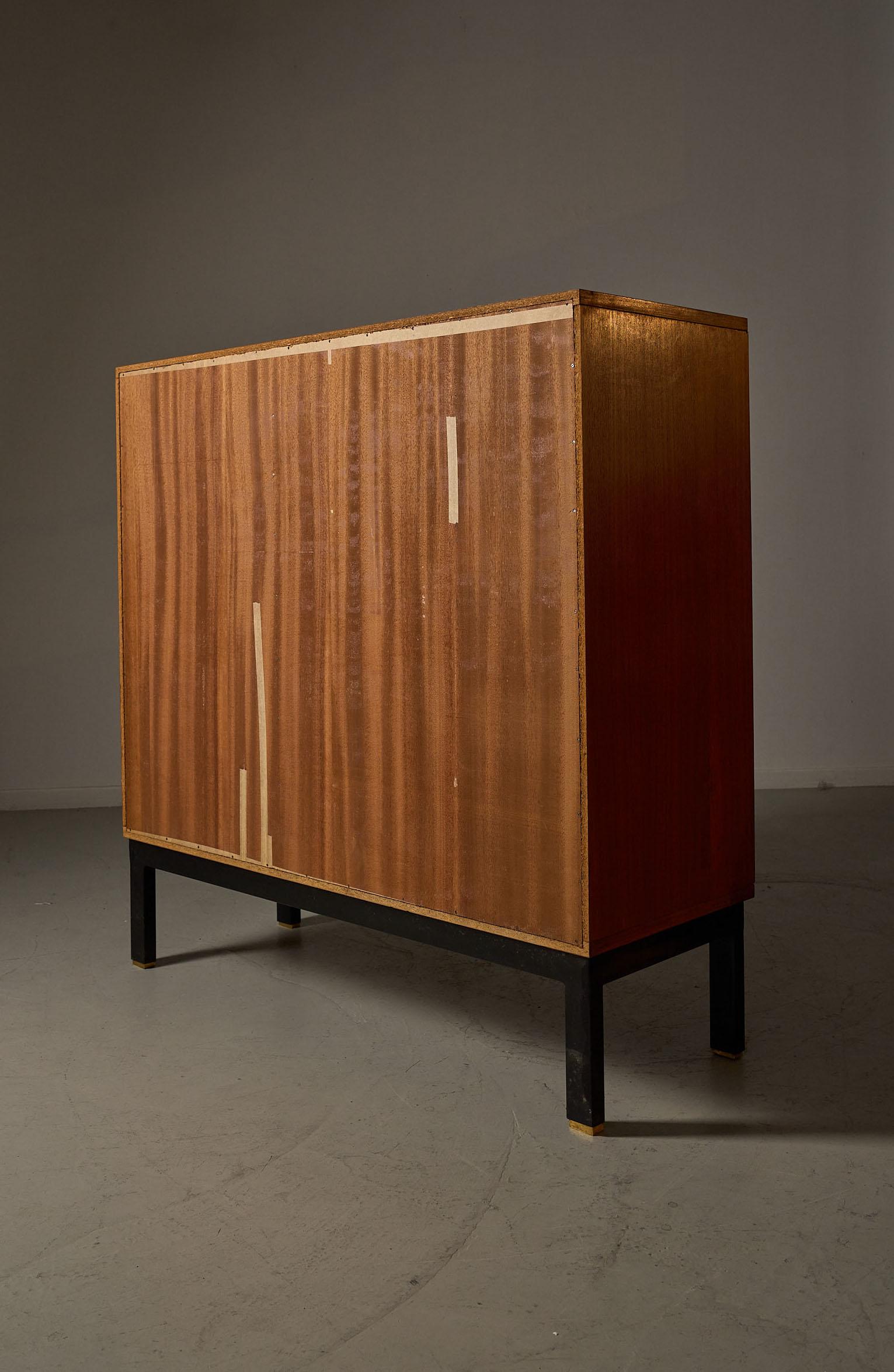 Teak cabinet with brass details & black metal base, 1970s
