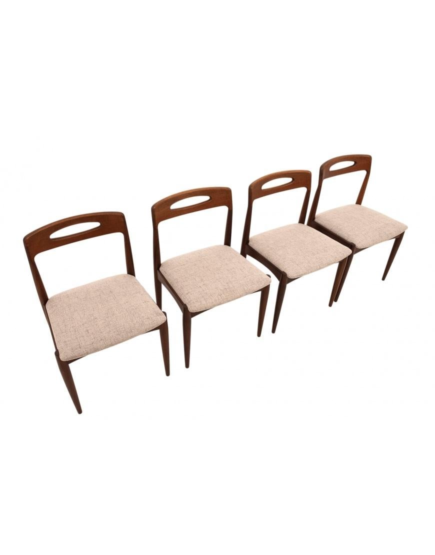 Four teak chairs designed by Johannes Andersen for Uldum Møbelfabrik. 

A classic of Danish design from the 1960s. The contoured backrest provides comfortable seating. The minimalist design will work great in today's modern interiors. 

Very good