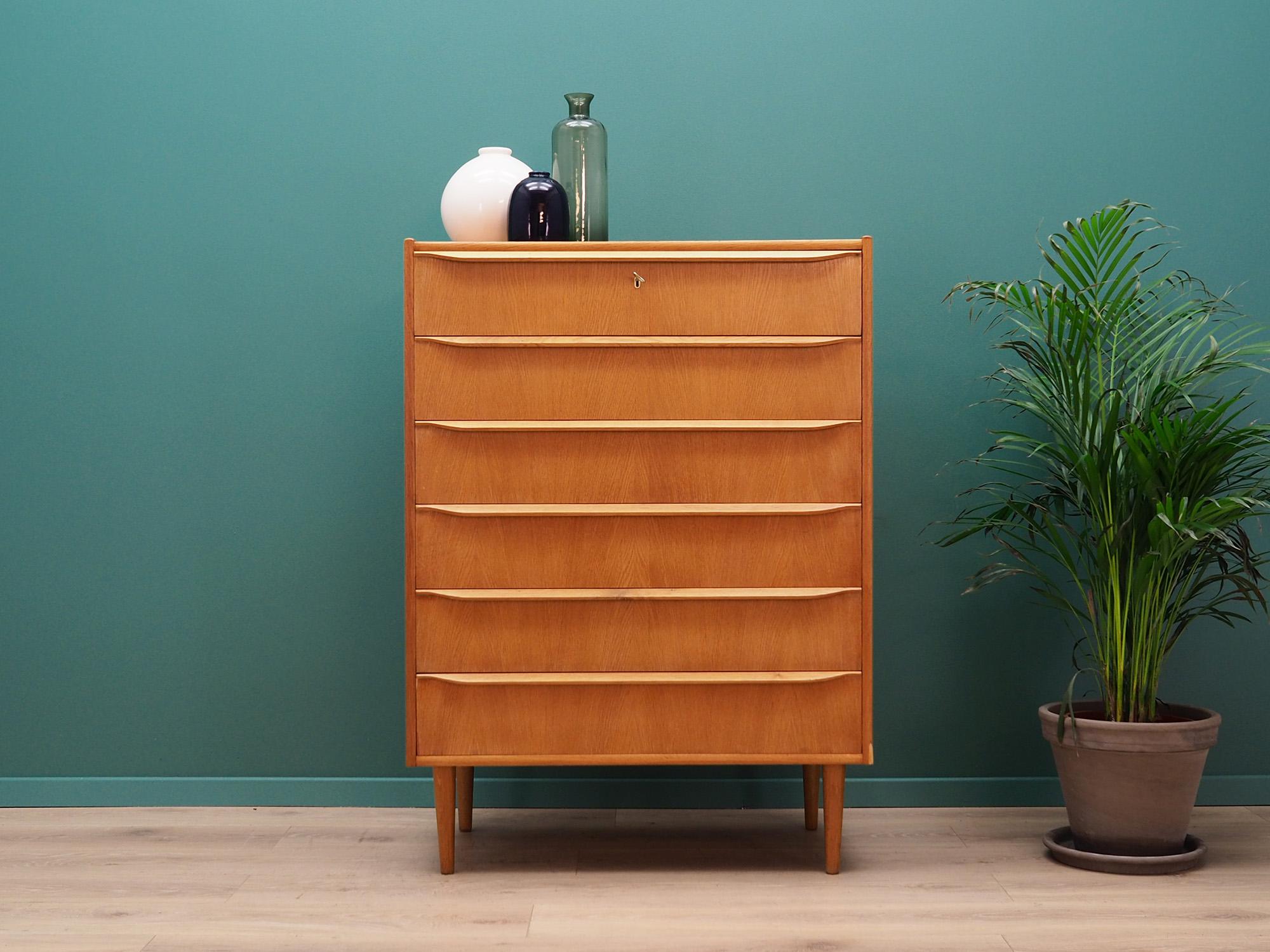 Classic chest of drawers from the 1960s-1970s. Danish design, Minimalist form. Surface finished with teak veneer. Furniture with six packed drawers, no key in the set. Preserved in good condition (minor bruises and scratches, filled veneer