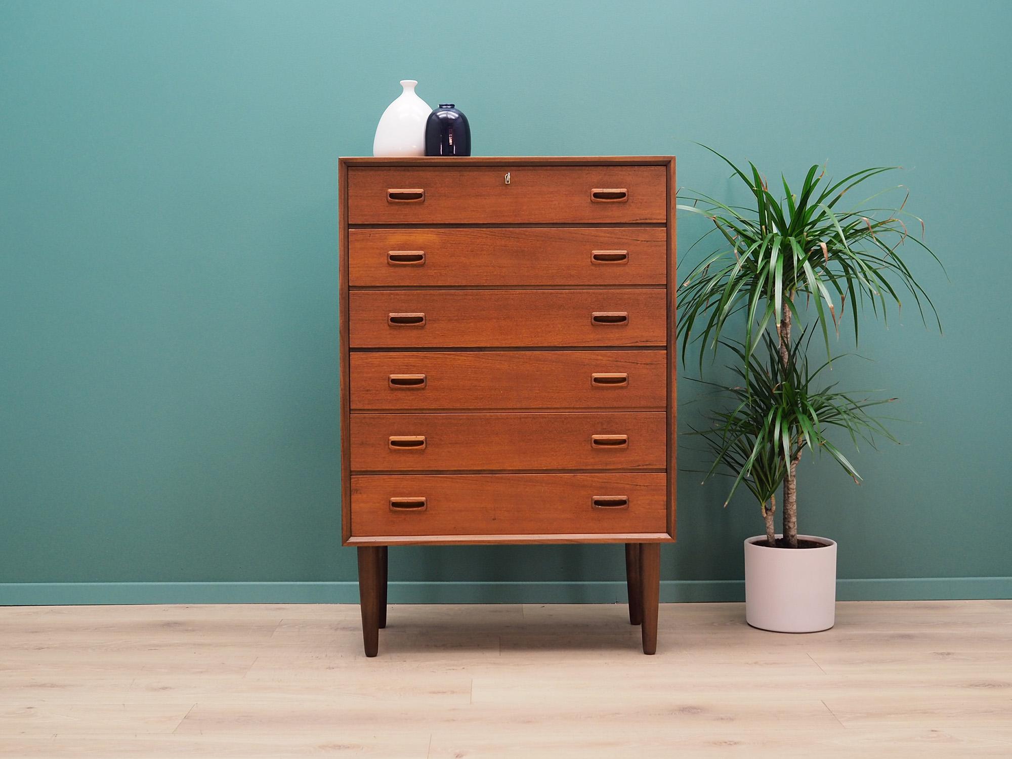 Exceptional chest of drawers from the 1960s-1970s. Minimalist form, Scandinavian design. Surface of the furniture is covered with teak veneer, legs are made of solid teak wood. Furniture has six spacious drawers, to which a key is attached.