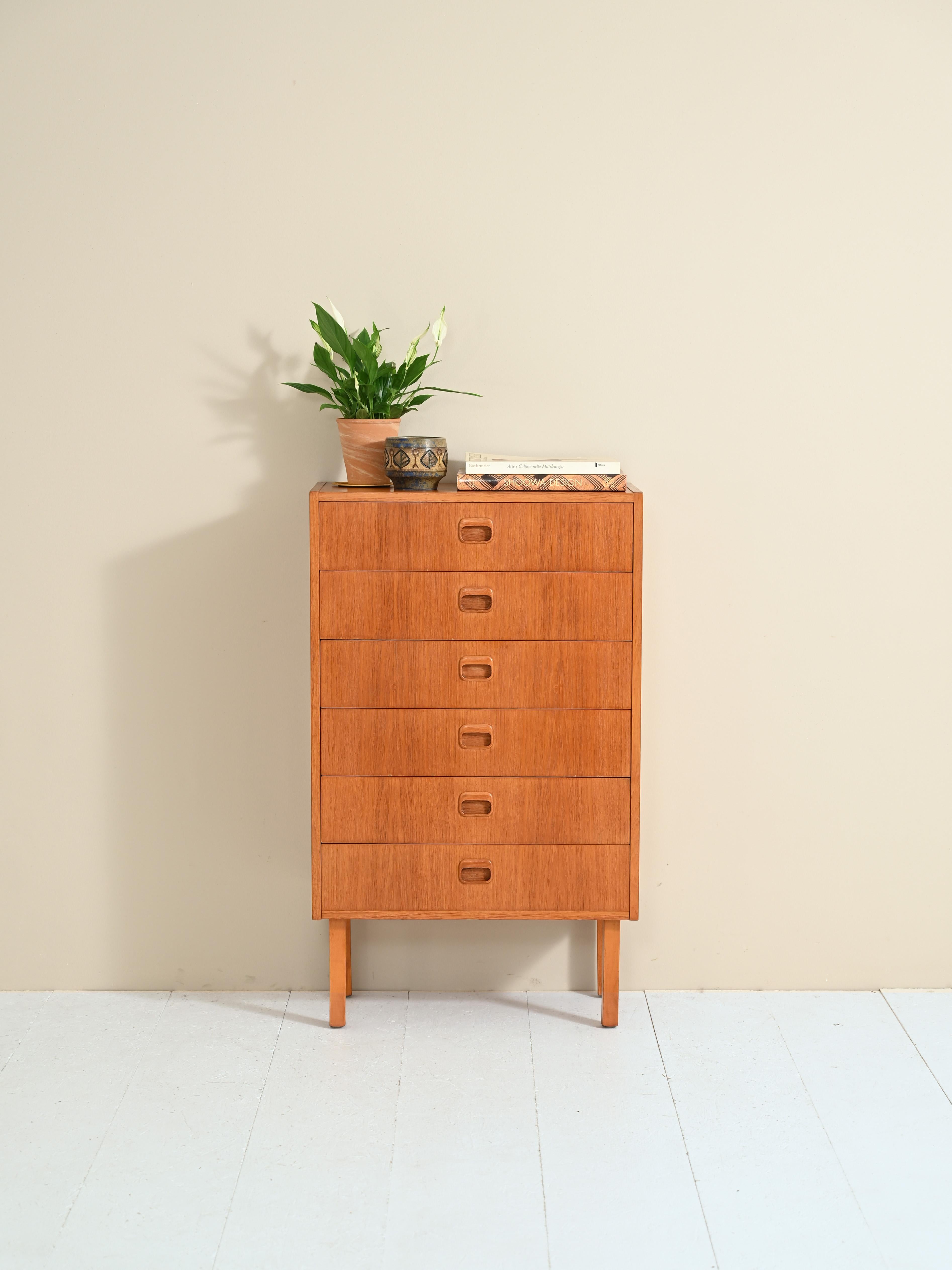 Vintage Scandinavian cabinet from the 1960s with six drawers.

Simple, linear forms for this chest of drawers in warm teak wood tones.

Good condition- May show signs of age- Have been treated with shellac and pure beeswax and carnauba wax.