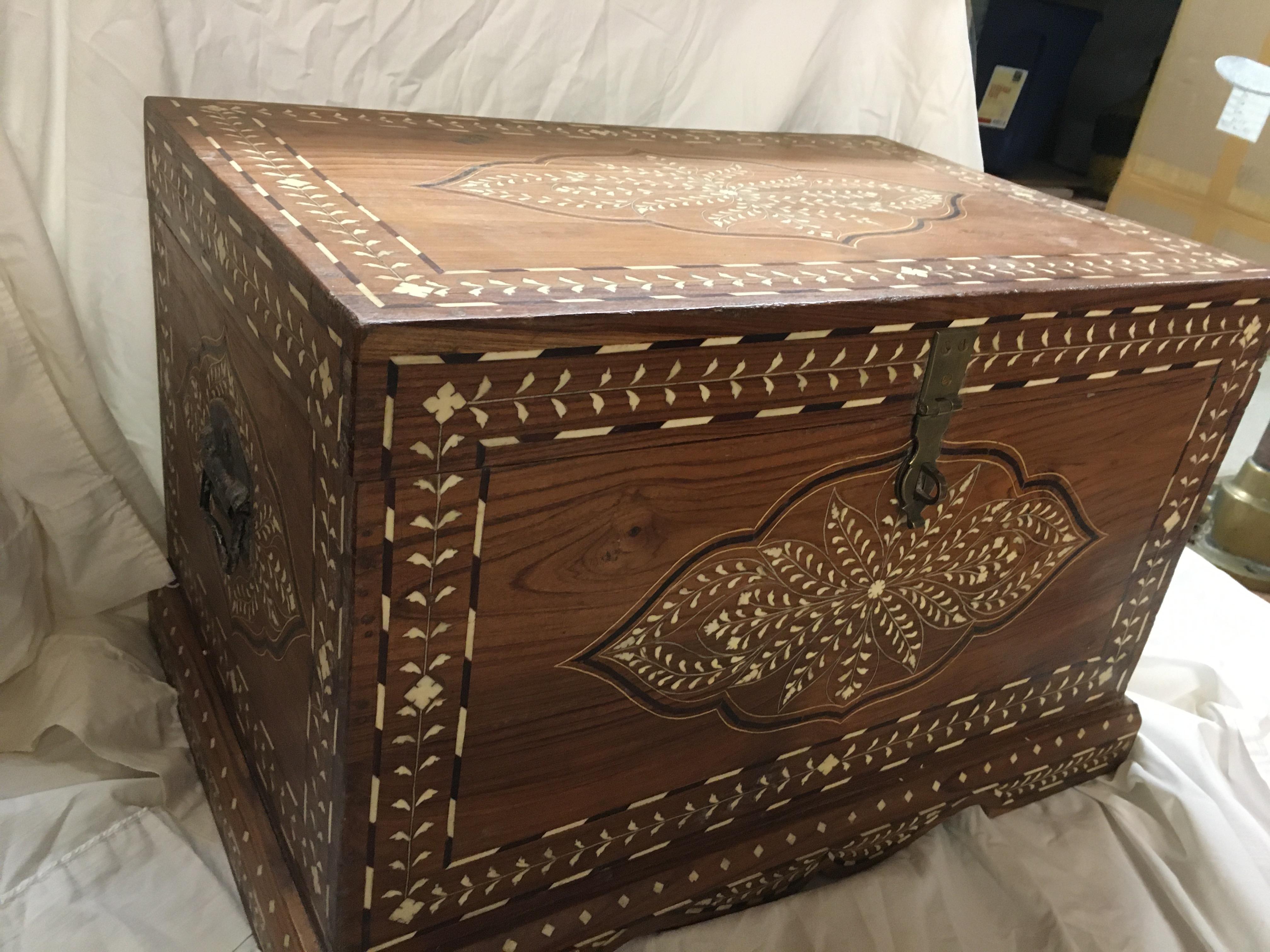 An incredibly intricate teak chest with bone (camel) and rosewood inlay. Always harder to work with smaller inlay pieces than large. Lovely patterns as well. Brass side handles and hasp. India, early 1900s. A couple of blemishes in the wood typical