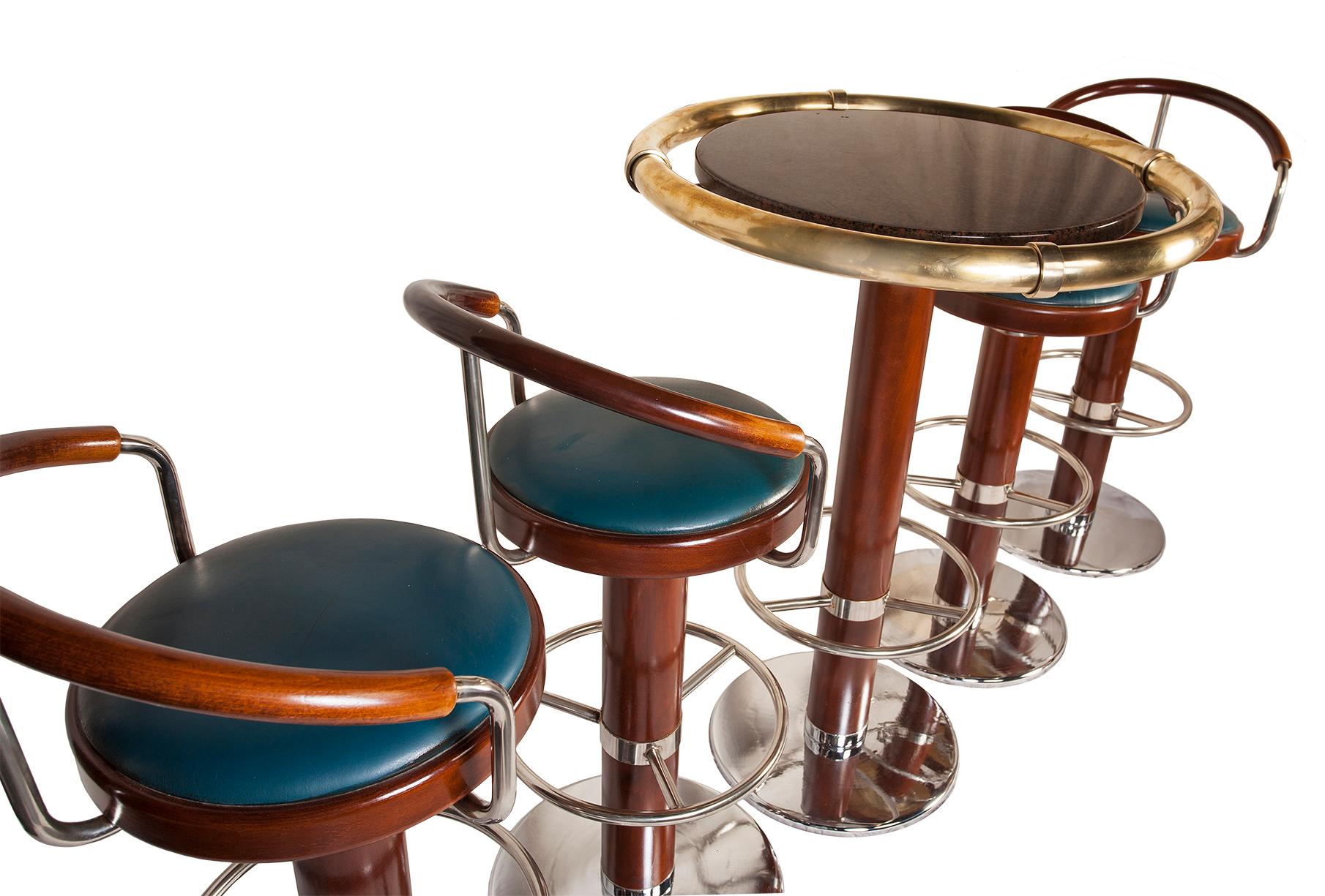 This is a fabulous find. These came from the decommissioned French cruise ship called the Ocean Gala, although she was originally Scandinavian. Four teak and chrome swivelling bar stools with the original blue faux leather seats. The high top has a