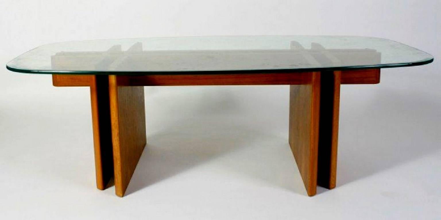 This marvellous cocktail table features an interlocking teak base with an oblong top of bevelled tempered glass. Stunningly elegant. Made in Denmark.

This item can be disassembled without tools for flat shipping.

We have the matching dining table
