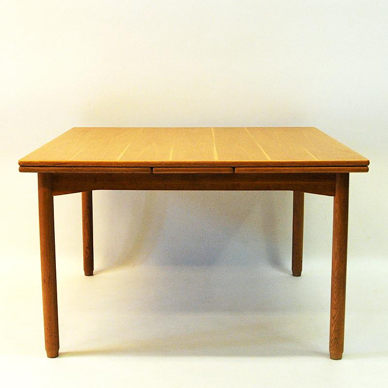 This is both a Coffee and Livingroomtable of solid teak with brighter and darker table topsections in the wood for a decorative look. The table can be folded and unfolded on each side then raised in higher position to fit as a diningtable with the