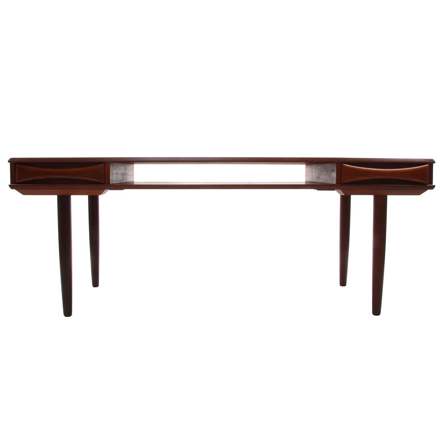 Teak coffee table by Danish furniture maker in the 1960s, beautiful Scandinavian Modern teak coffee table with shelf and two drawers, in very good vintage condition.

A gorgeous midcentury piece, crafted in teak, rich in color and proudly showing