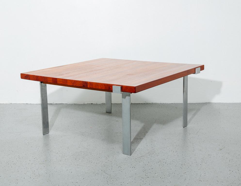 Modernist coffee table with solid teak top and stainless steel base. Designed by Illum Wikkelso for Mikael Laursen, Denmark.