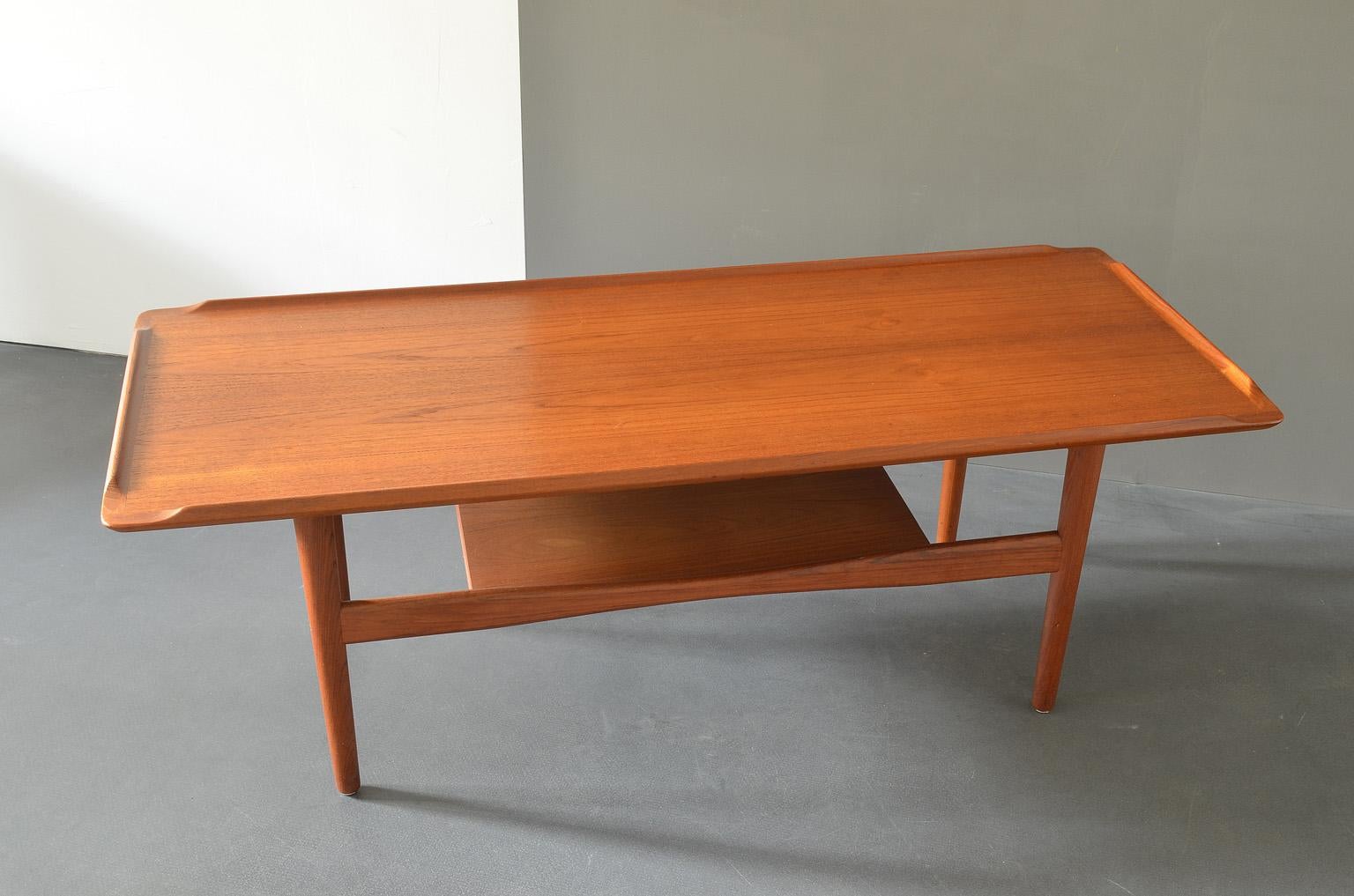 This teak coffee table was produced by IMHA in the 1960s, Germany.