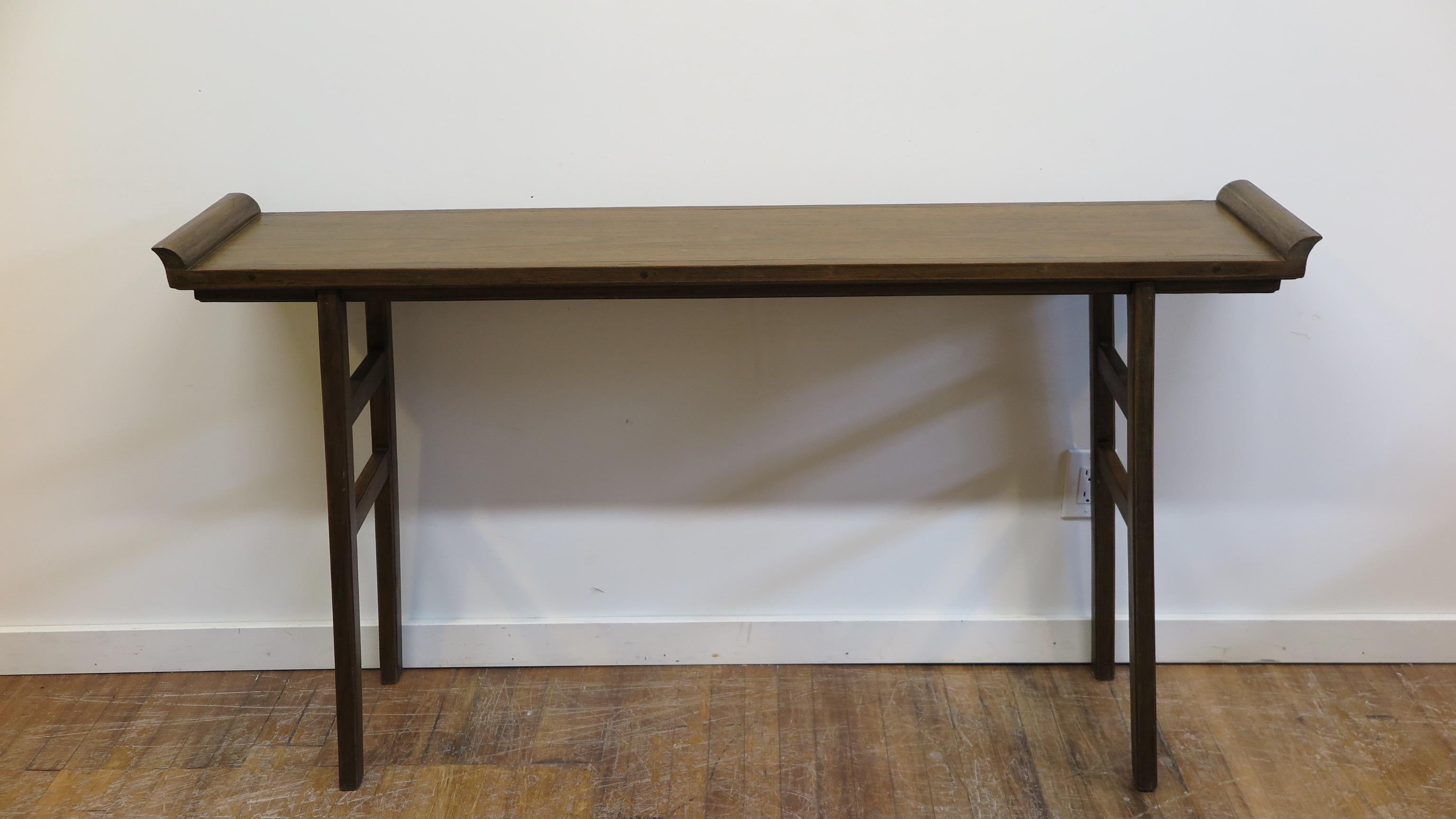 Teak console table with averted flanges and splayed legs.  Clean lines with shallow depth and mid century design elements.   Perfect for tight spaces or where thin profile is preferred.  Solid Teak wood. In very good condition.  