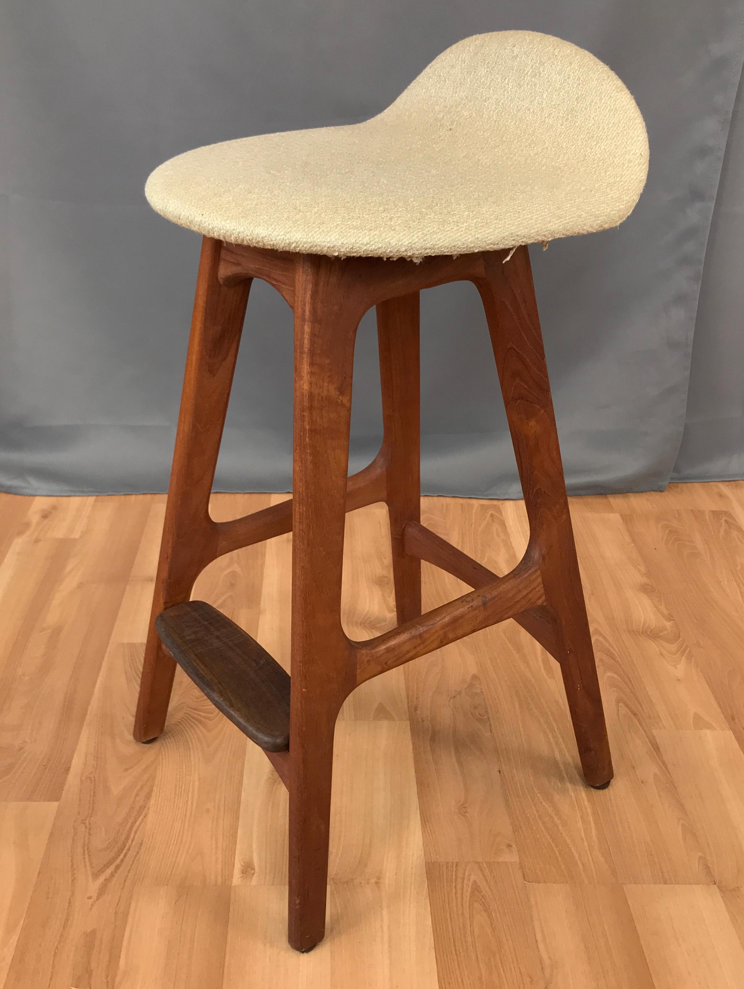 Teak counter height stool designed by Erick Buck, Denmark, circa 1960s.
Wool upholstery seat, which curves up a little for mini backrest. Foot rest in front is a nice large oval piece of teak.
Label on the underside is worn, but still shows it's