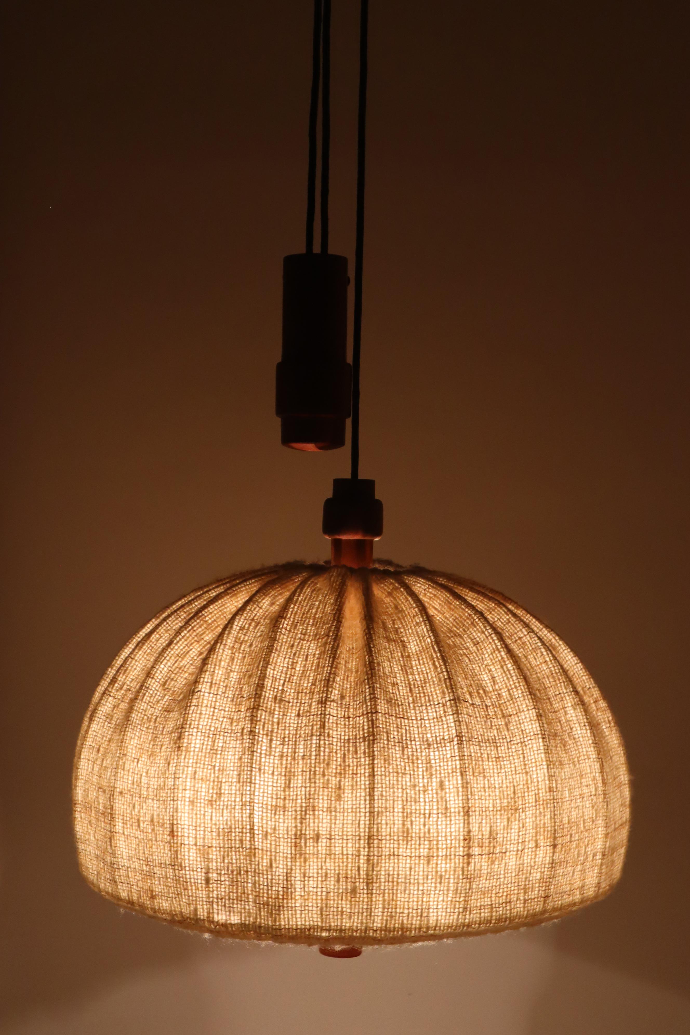 This is a large Danish hanging lamp by Domus from Denmark. it is on from the Scandinavian Mordern in 1970s. Its is important to note that this is a counterweight lamp meaning the height or length can be adjusted, in the photos it was adjusted to