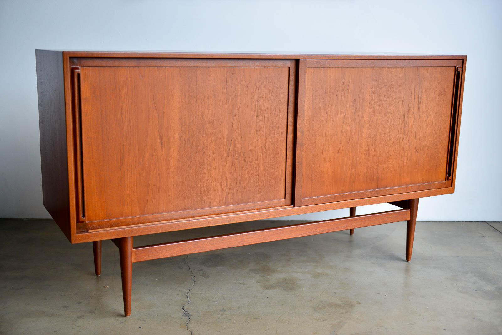 Teak credenza by Cabinetmaker Erik Worts, Denmark 1959. Purchased by original owner from Den Permanente, Copenhagen in 1959. Provenance available. Professionally restored in showroom condition this rare piece shows off the delicate base and legs