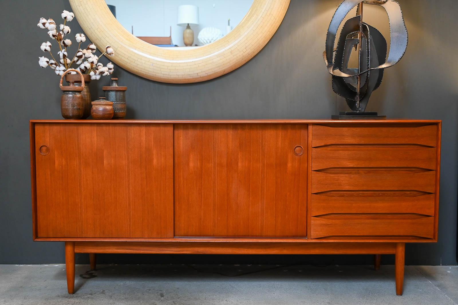 Teak Credenza by Johannes Aasbjerg for Aasbjerg & Ørtoft, ca. 1960.  Johannes Aasbjerg designed for his company, Excellent Furniture Company in Denmark.  This cabinet is exceptional with solid teak outer cabinet frame with exposed edge joinery and