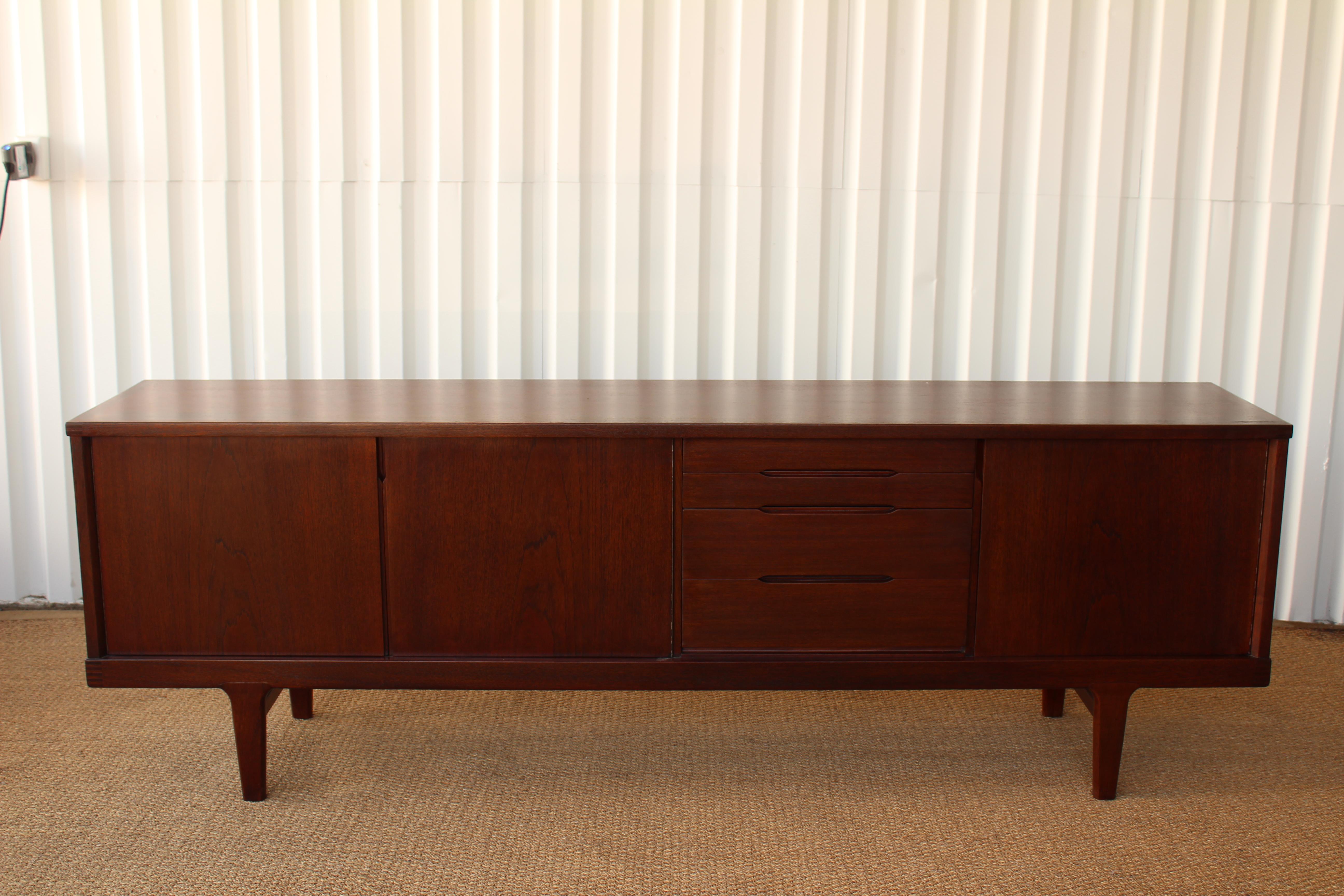 Long credenza in teak, with an oak interior. Made in Denmark, 1950s. Unmarked, unknown designer. Recently refinished. Features adjustable shelving and 4 drawers.