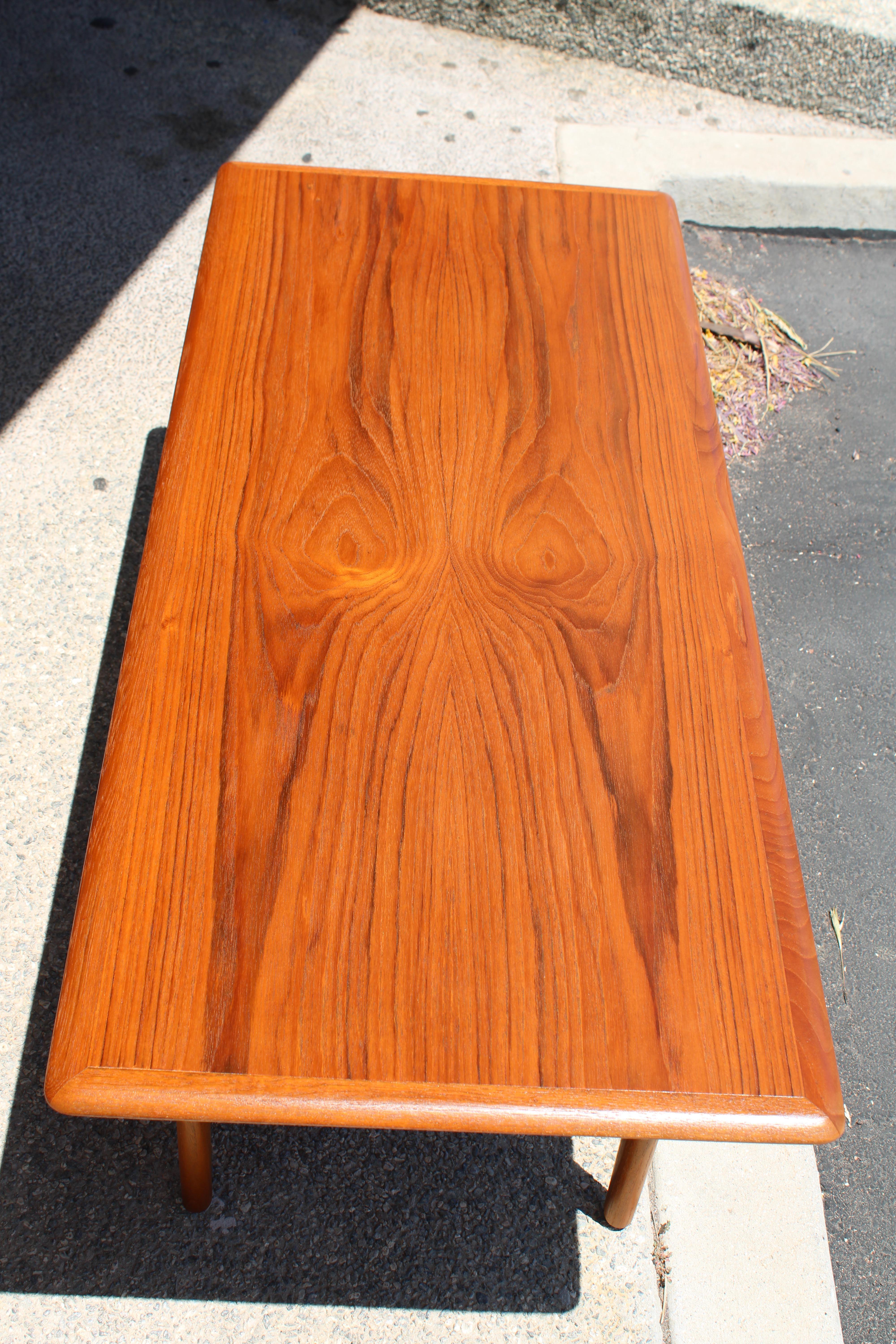 Teak Danish coffee table with an incredible wood grain pattern. Table measures 47