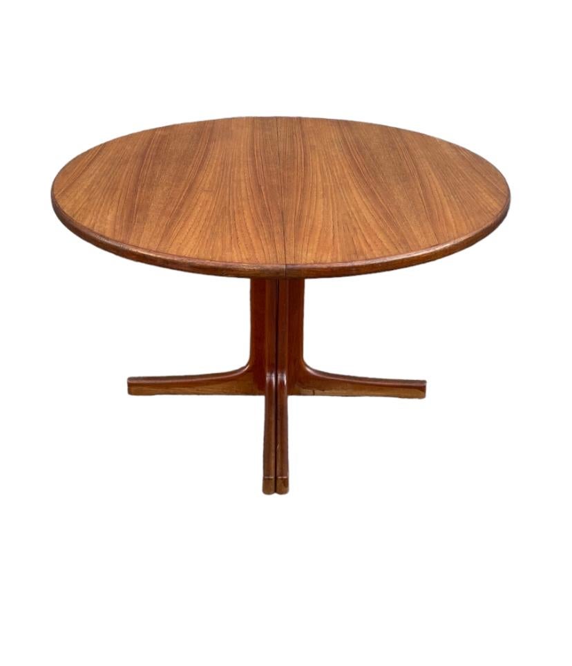Danish modern teak dining table. 48” diameter round table. Scandinavian Mid-Century Modern design with stunning grain.