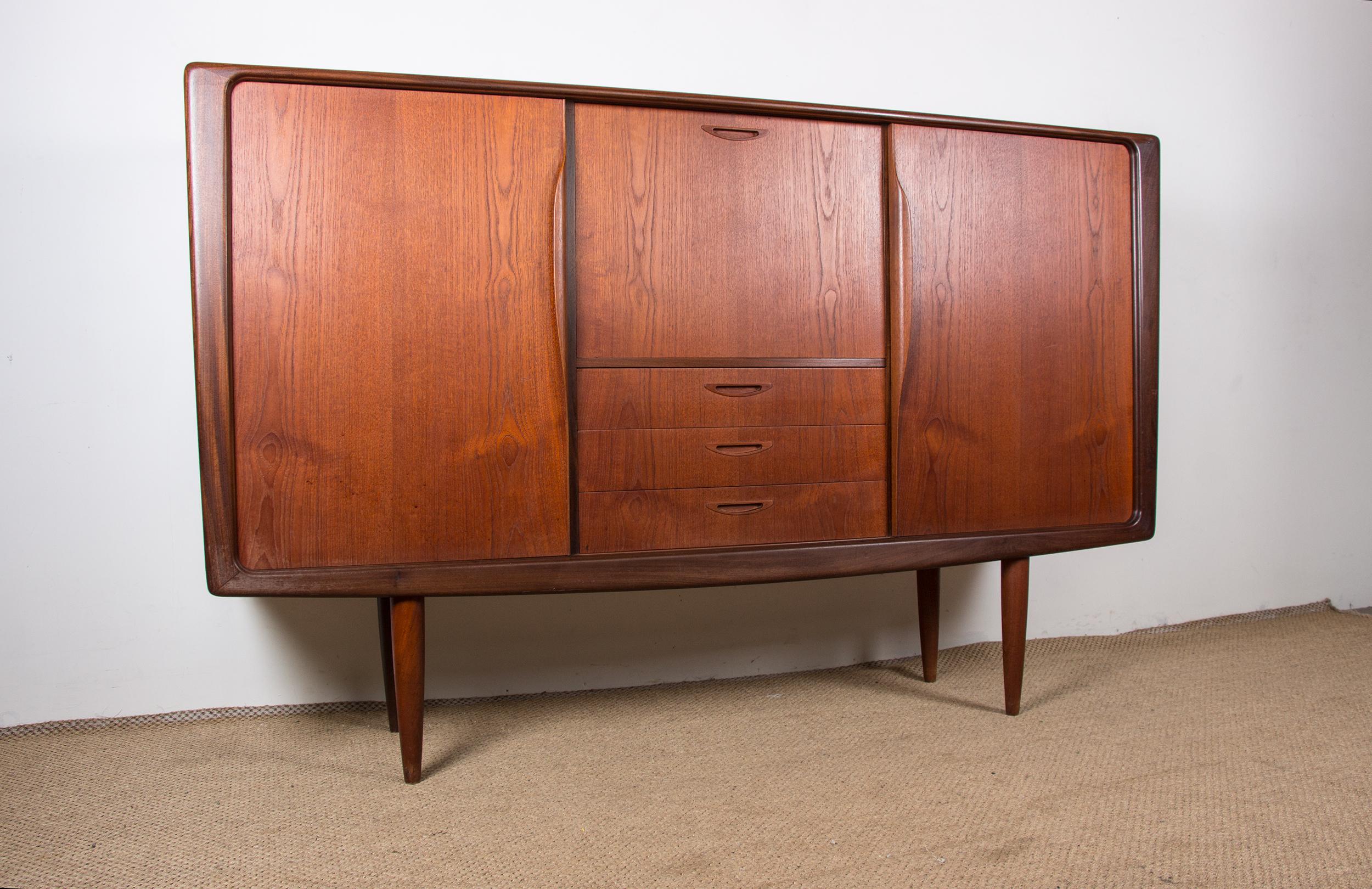 Superb Scandinavian highboard. Two large doors slide along the entire length and open on each side onto 2 large shelves. On the central part, a folding door on the top which opens on a shelf for storage, bar or secretary. 3 large drawers below.