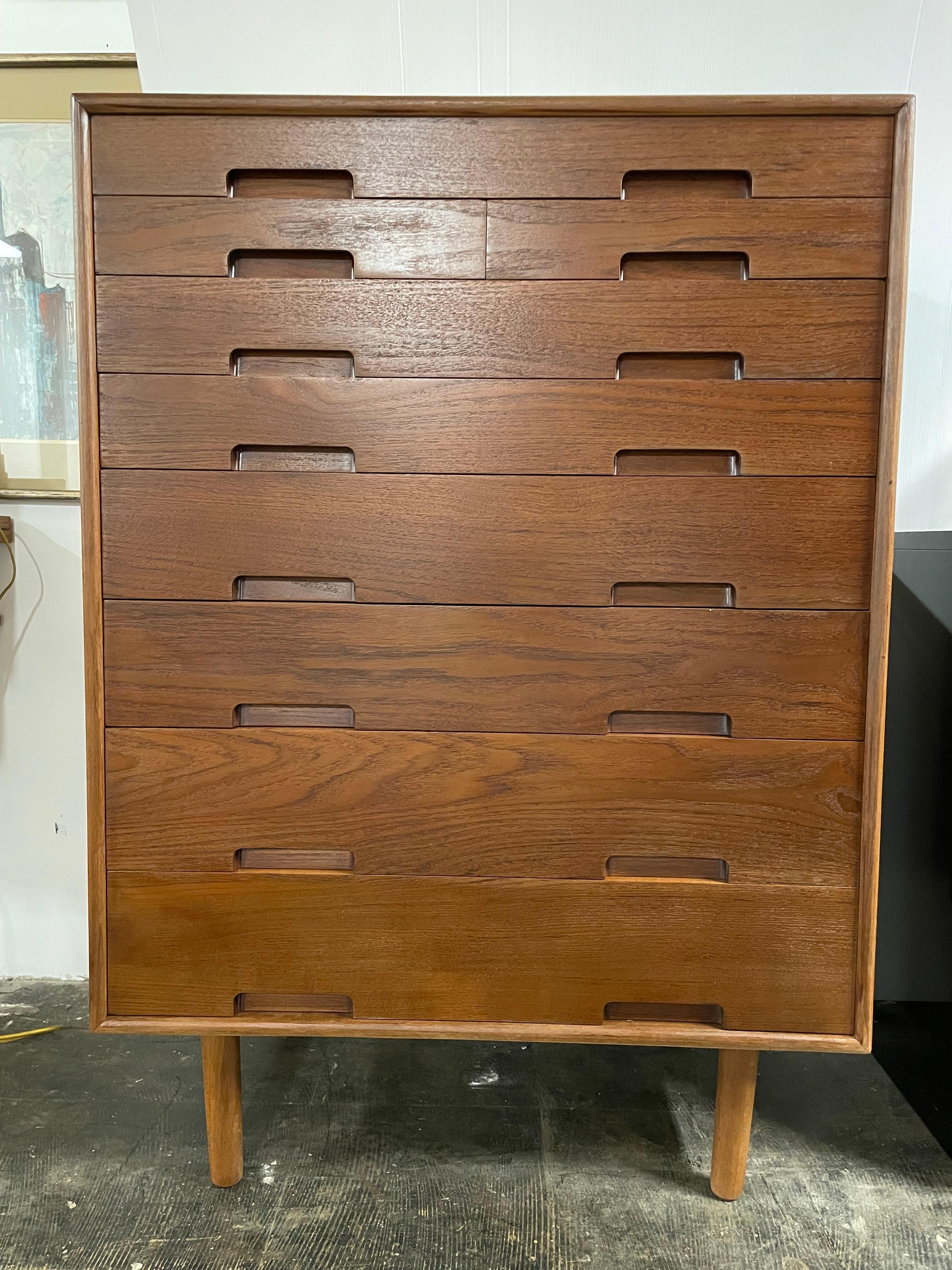 Gorgeous teak Danish highboy dresser. Features 8 rows of drawers in different sizes.