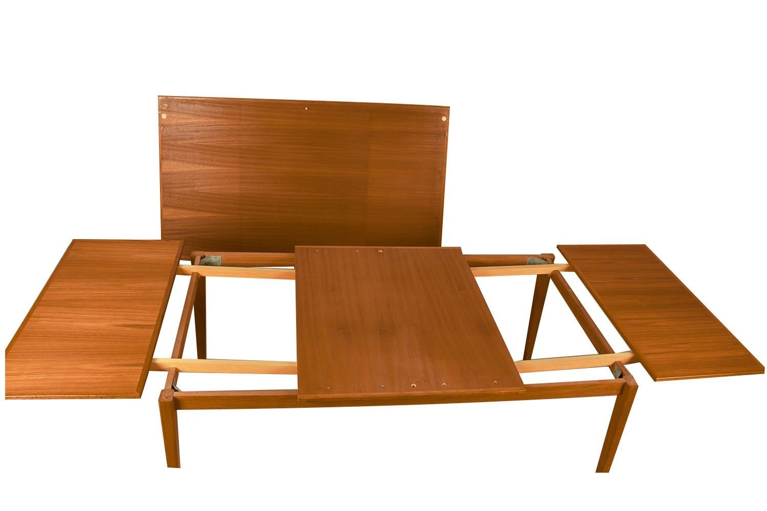 An exceptional, Danish, Modern, teak draw leaf Expandable dining table, by Willy Sigh for H. Sigh and Sons Mobelfabrik, Denmark 1960s. With an initial large footprint, this table can also offer a generous space and double in size once its hidden