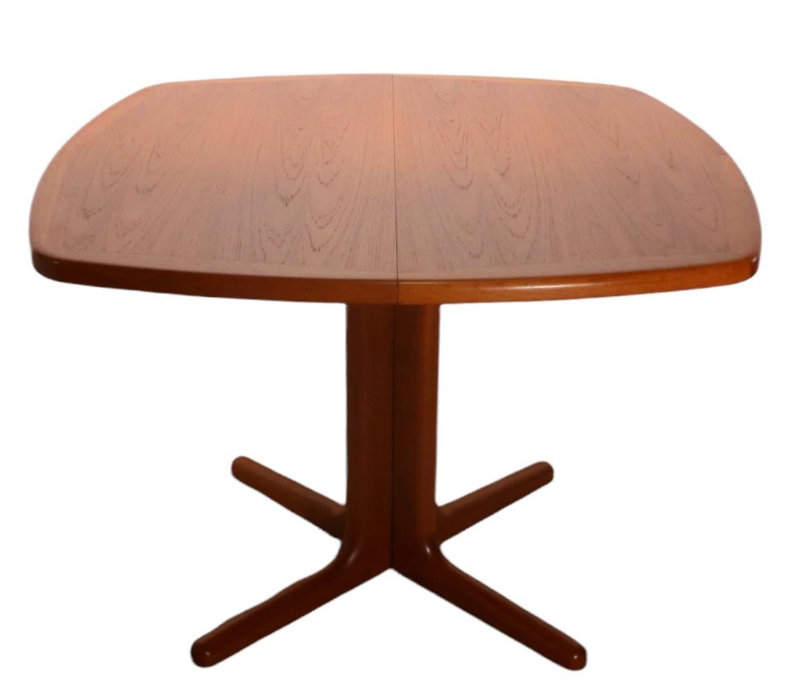 Exceptional Danish Mid-Century Modern dining table designed by Edvard Valentinsen, made in Denmark circa 1960's.
 The table is in unusually clean original condition, it comes with one large ( 18 in. ) leaf and ahas a split pedestal style base. The