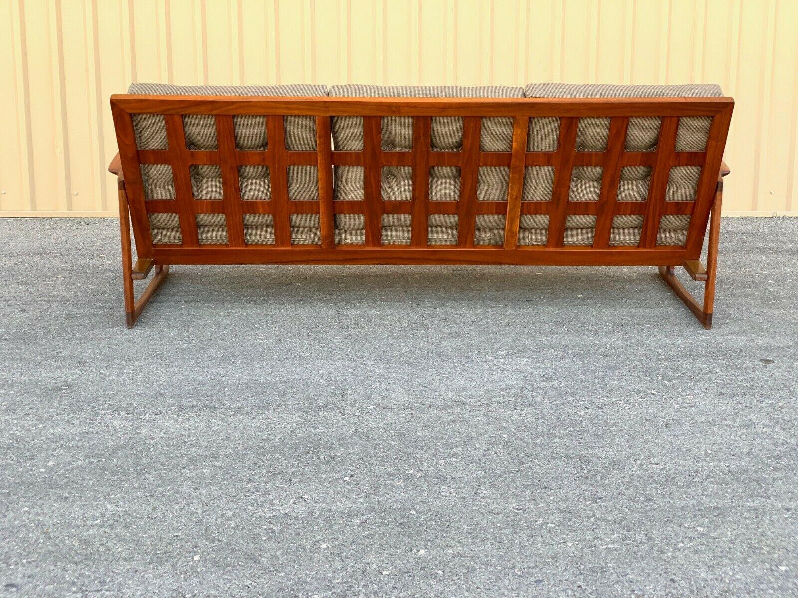 Vintage, mid century, Danish modern, sofa designed by Ib Kofod-Larsen for Selig features a distinct, solid Teak frame with lattice back and sleigh leg base. 

“In excellent condition frame has been Professionally refinished. Upholstery in good