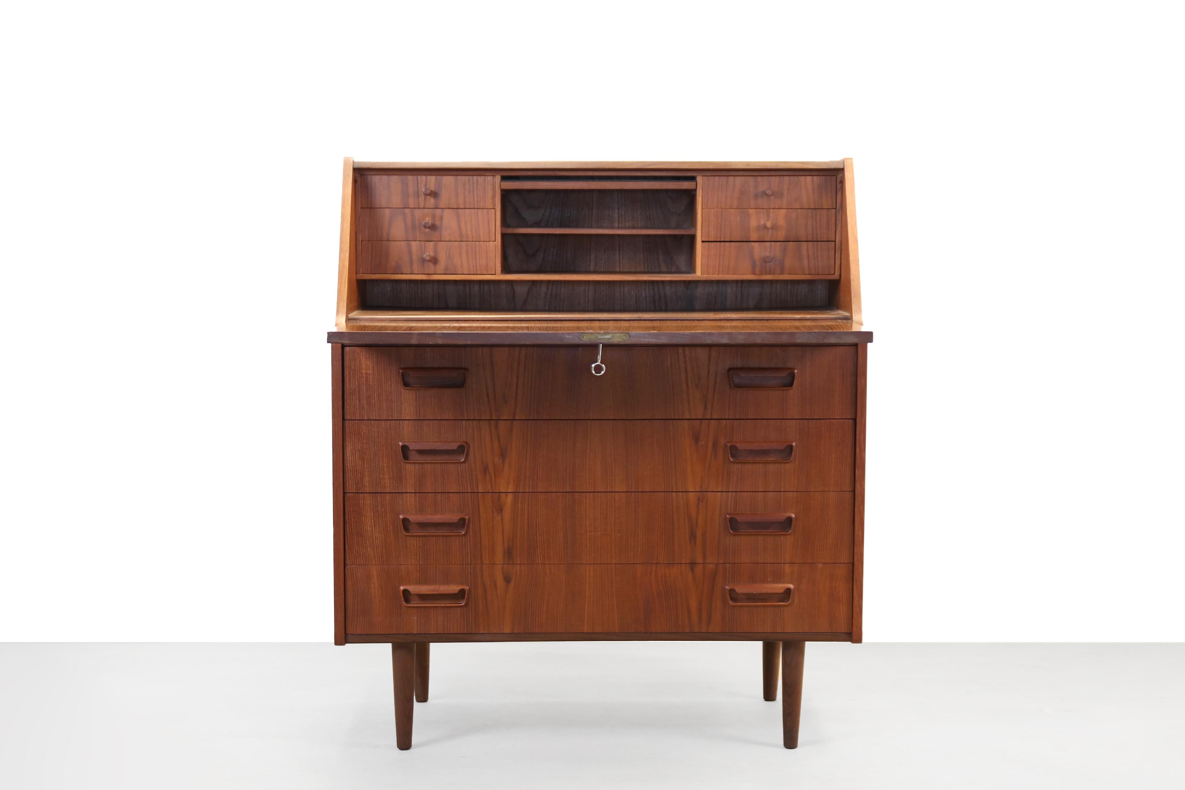 Beautiful secretary desk designed by Gunnar Nielsen Tibergaard and produced by Tibergaard Denmark in the 1960s in Denmark. The lid of the desk is also the desktop when it is folded open. Several storage compartments and drawers can be found behind