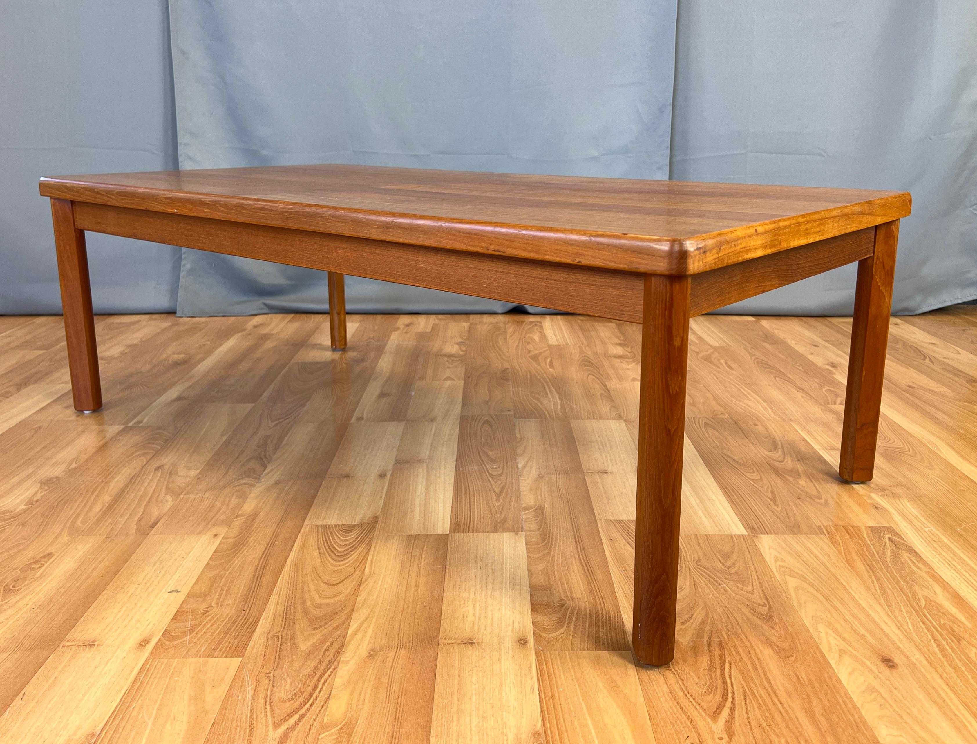 A simple clean design this Danish modern coffee/cocktail table has. 
Solid teak legs and edges, it's a nice size, you could say it's just right.