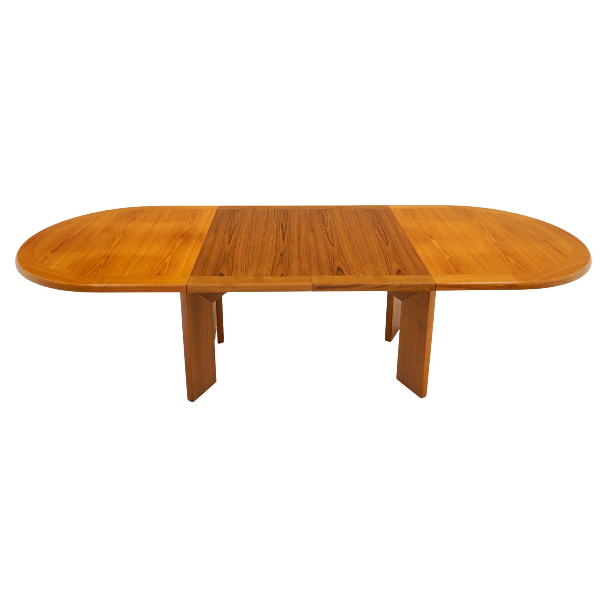 Mid-Century Modern teak dining table by Skovby, Denmark, 1970s. Heavy duty construction with thick top and angled legs. Great design with two large leaves that store inside the table. The table top opens without the legs moving on the floor making