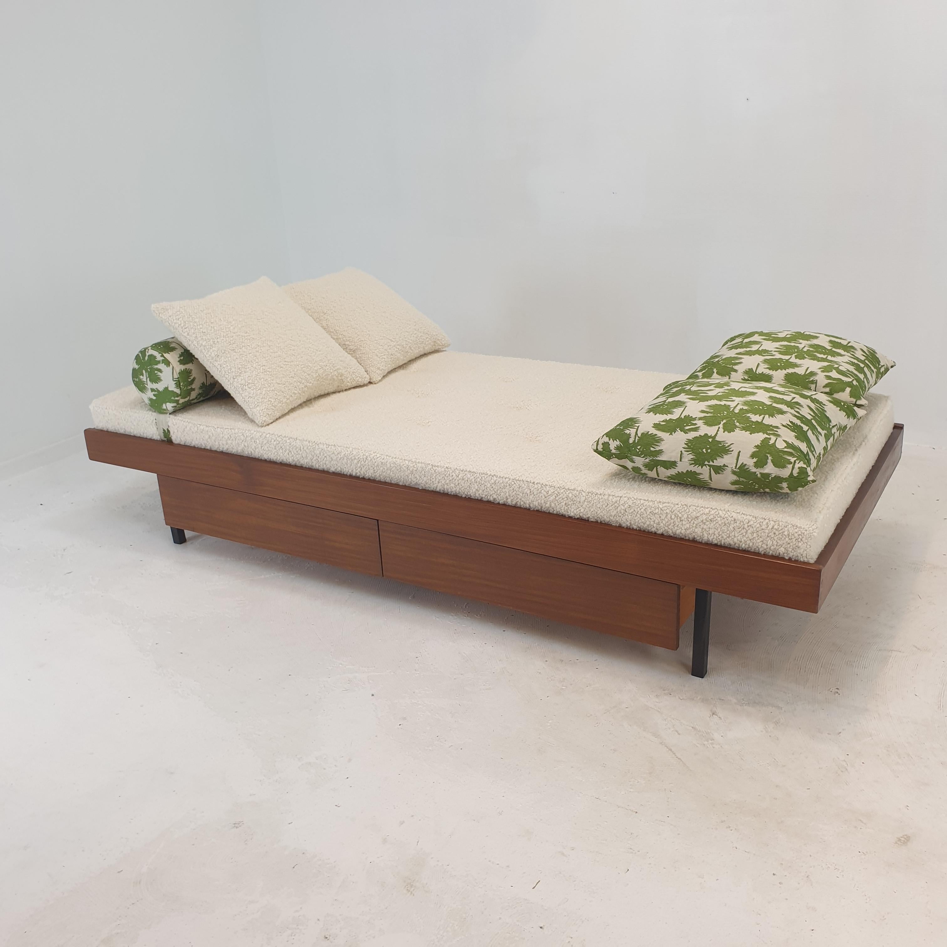 Very nice teak daybed, fabricated in The Netherlands in the 60's. 
Underneath the bed there are two drawers.

The mattress is renewed with new foam and it has just been upholstered with lovely wool fabric, the same for two cushions.

The bolster and