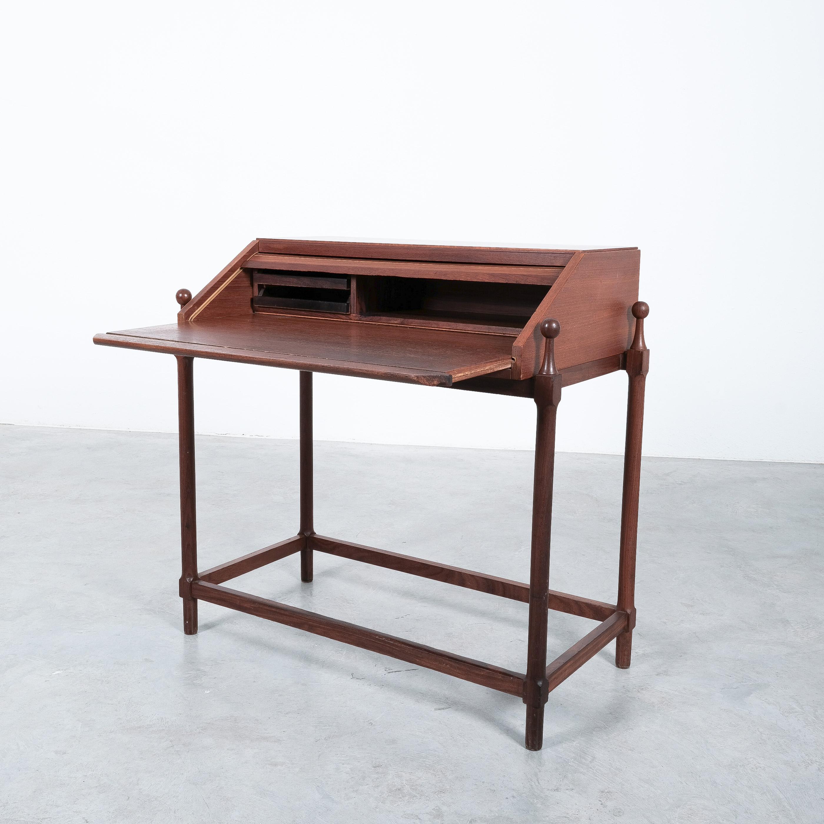 Teak rollup secretary desk by Fratelli Proserpio, Italy 1960's.

Modernist compact writing desk, perfectly sized and in good vintage condition. It shows a unique mechanism that opens as you pull out the writing surface. The interior cabinet has a