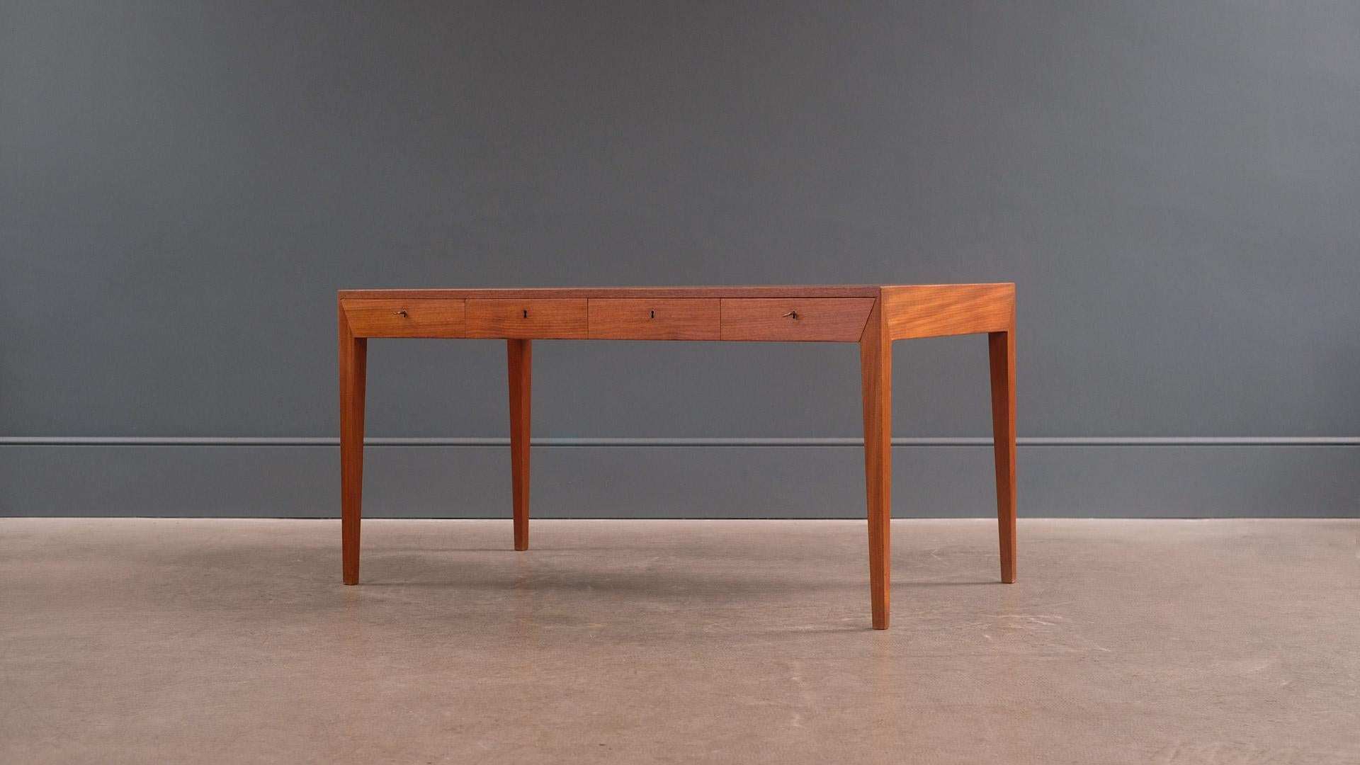 Super sought after desk designed by Severin Hansen for Haslev, Denmark. The most elegant Danish desk of the period with wonderful details. This example in rarer teak with beautiful grain. Great piece.