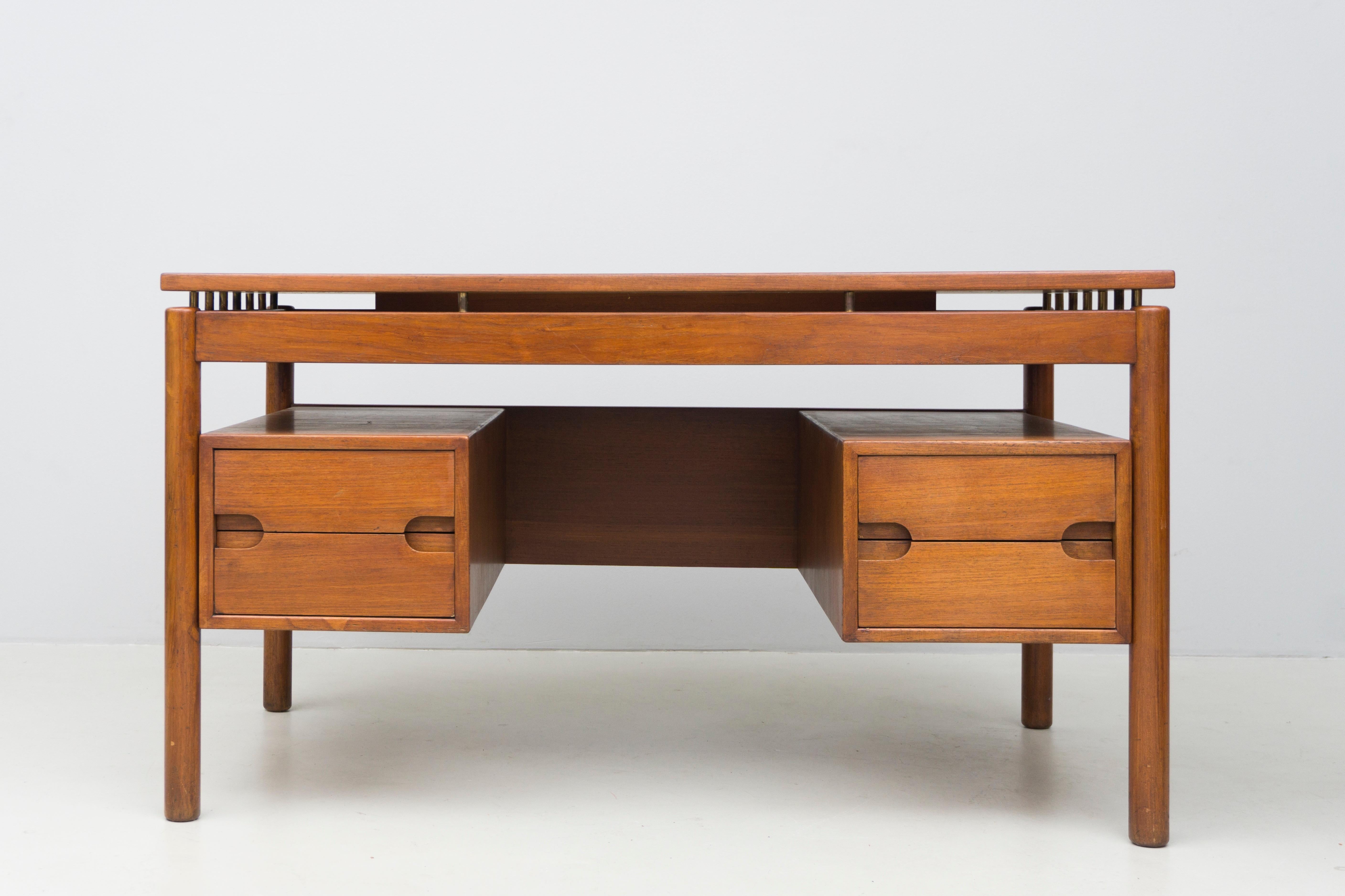 Wooden desk made by finish designer Ilmari Tapiovaara, made of solid teak wood with drawers and brass details.
Labeled 'La Permanente di Cantú'

Ilmari Tapiovaara (1914-1999) graduated in interior design and worked for Asko. He would count Alvar
