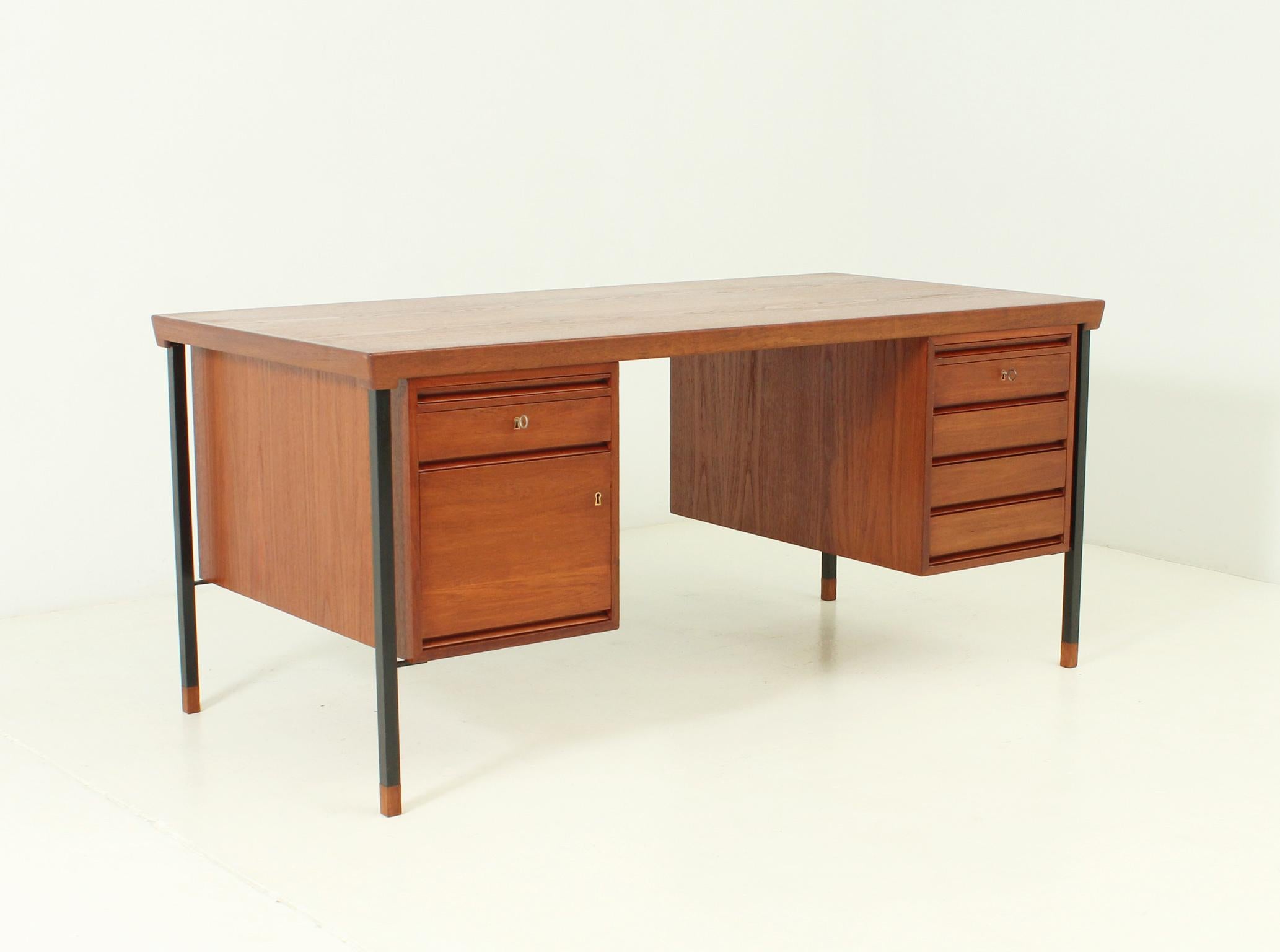 Desk designed in 1959 by danish architects Peter Hvidt and Orla Mølgaard-Nielsen for Søborg, Denmark. Two and four drawers and two writing surfaces with interior glasses, open shelves in front side. Teak, glass and lacquered metal.
