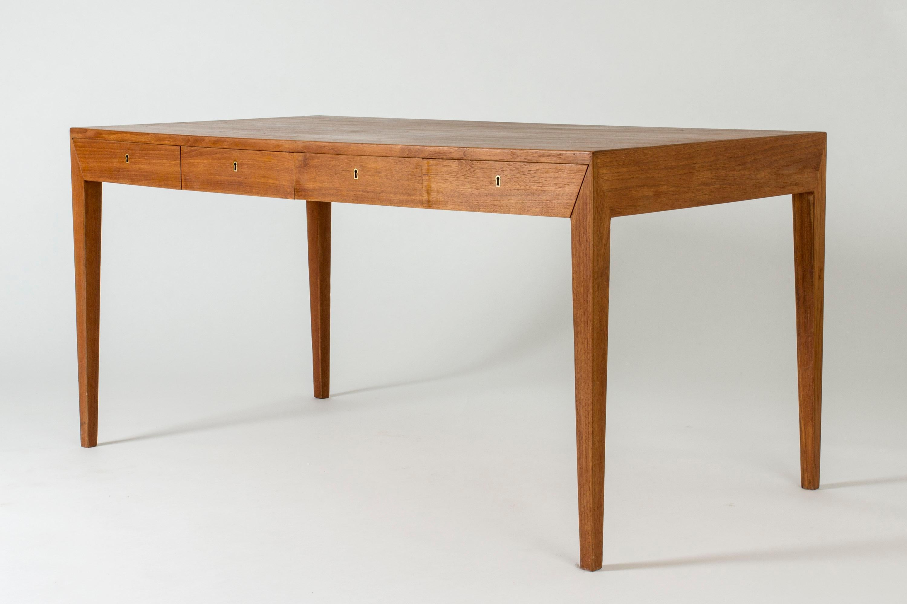 Striking teak desk by Severin Hansen. Great proportions and Severin Hansen’s characteristic diagonal, seamless joinery at the corners. Four drawers with a brass key.