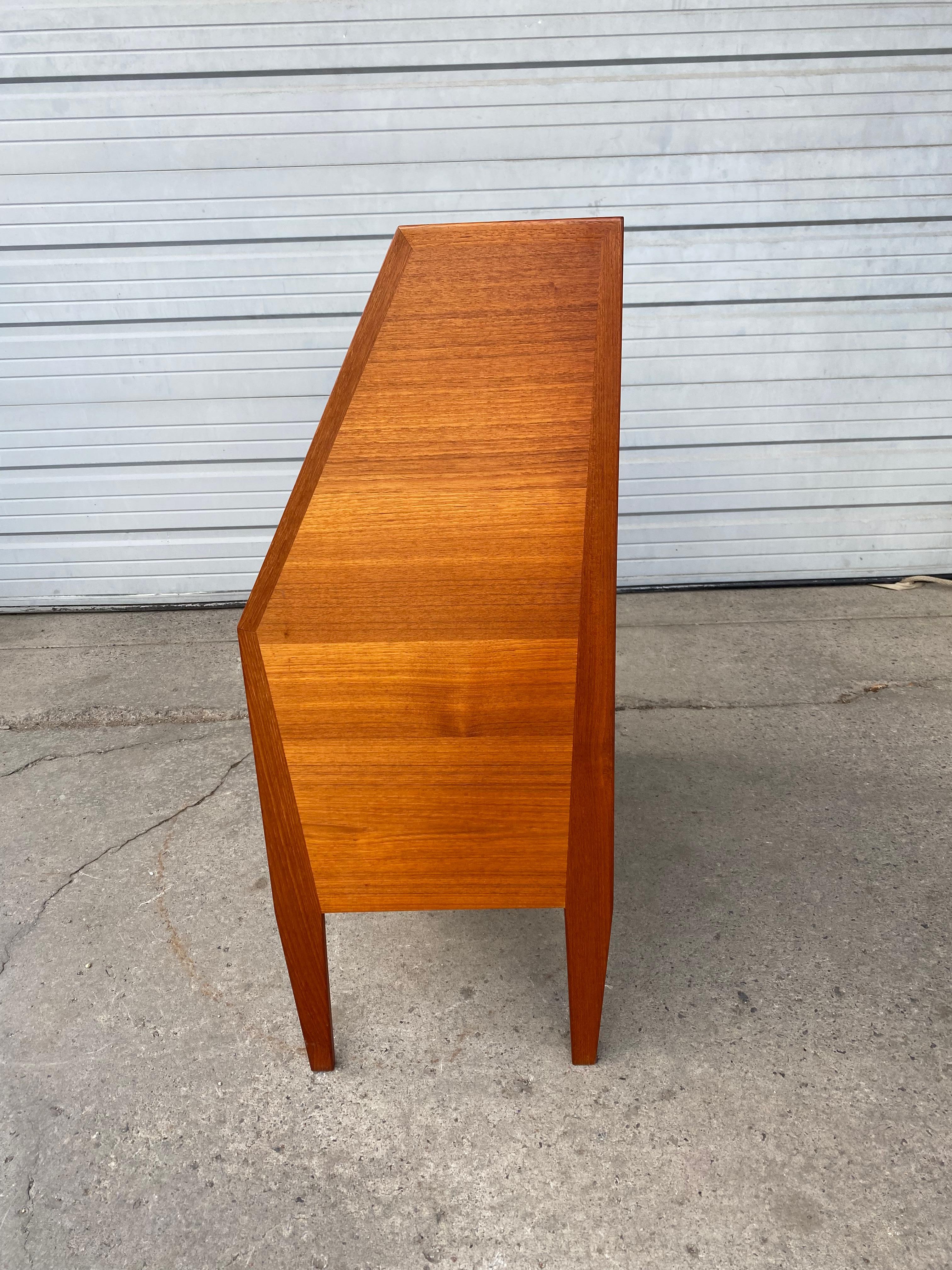 Beautiful secretary desk attributed to Gunnar Nielsen Tibergaard and produced by Tibergaard Denmark in the 1960s in Denmark. The lid of the desk is also the desktop when it is folded open. storage compartments and drawers can be found behind this