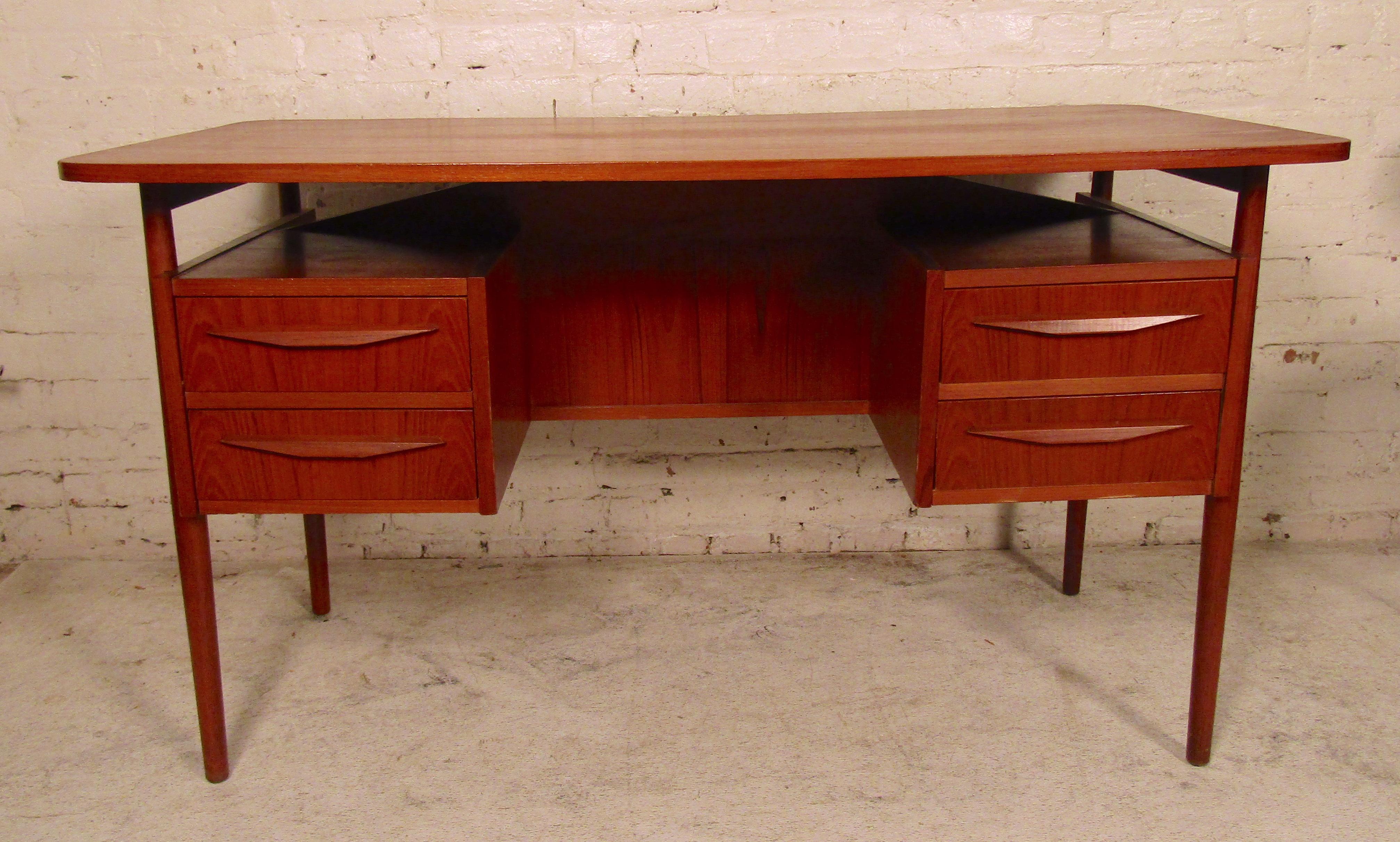 Mid-Century Modern Danish desk by Maurice Villency. Features teak grain, floating top and open storage back.
(Please confirm item location - NY or NJ - with dealer).
  